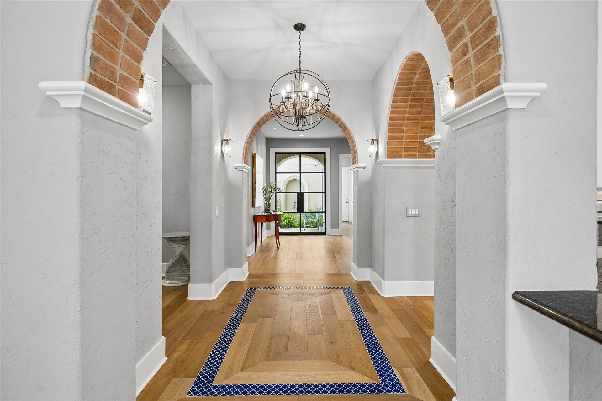 View of the arched entry ways and hallway towards the front door.