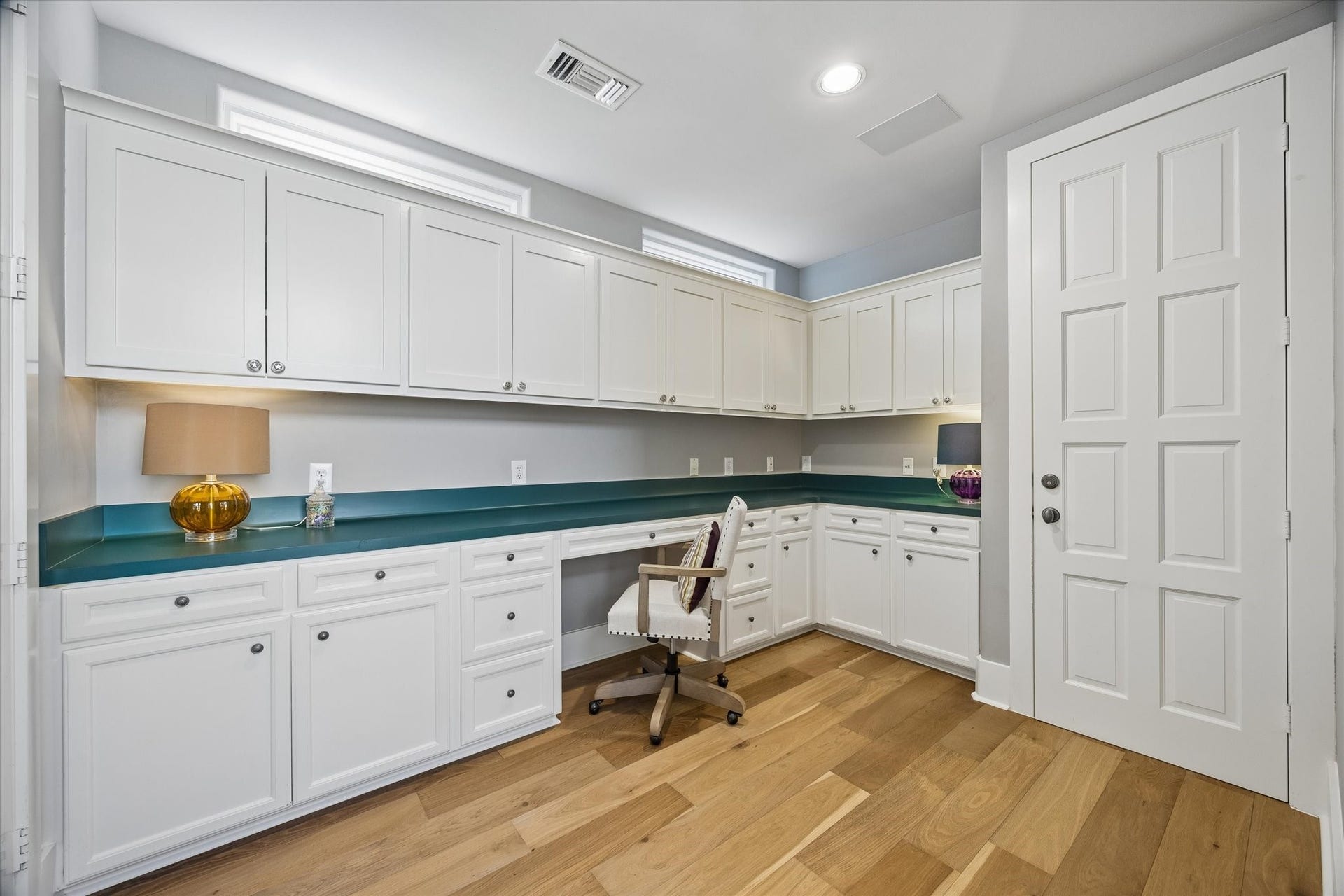 Downstairs home office or hobby room outfitted with amazing storage.