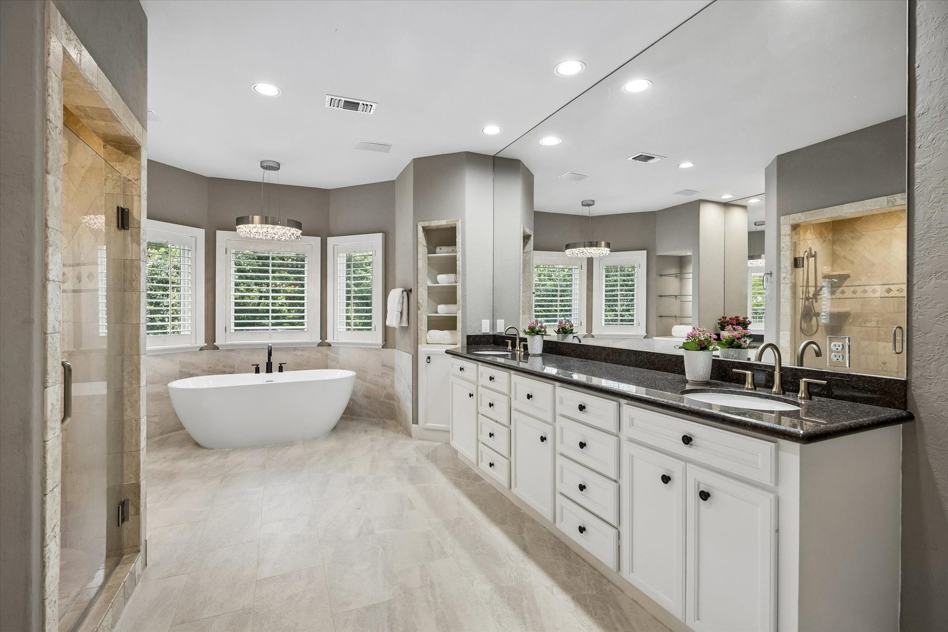 Walk-in shower with seamless glass door, double sinks and lots of storage.