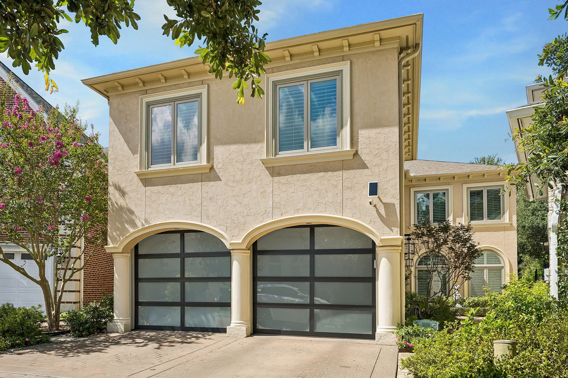 Many updates throughout including glass paneled garage doors, hardwood floors, glass and steel front double door entry...