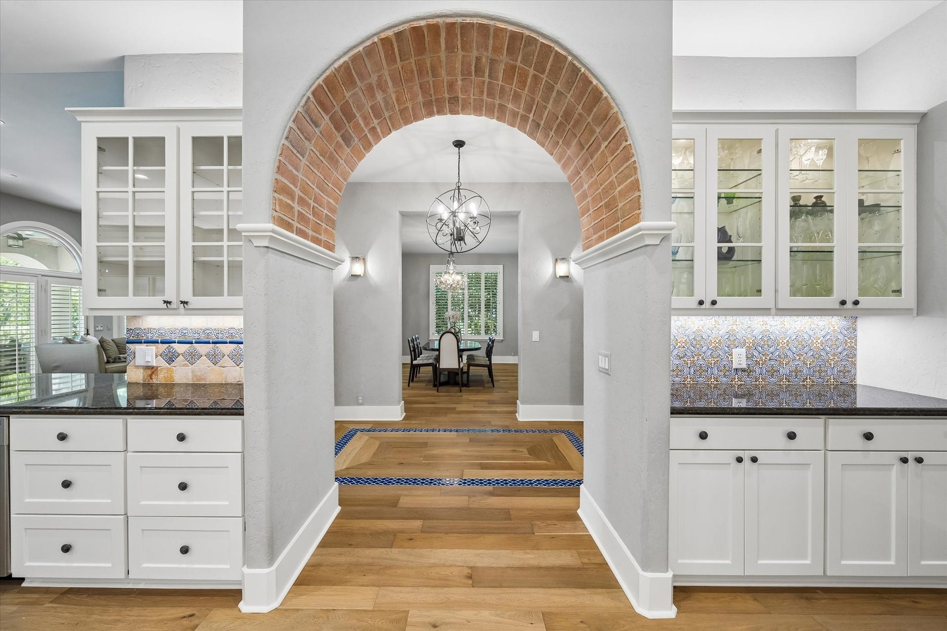 Kitchen flows to dining across hall for seamless entertaining.