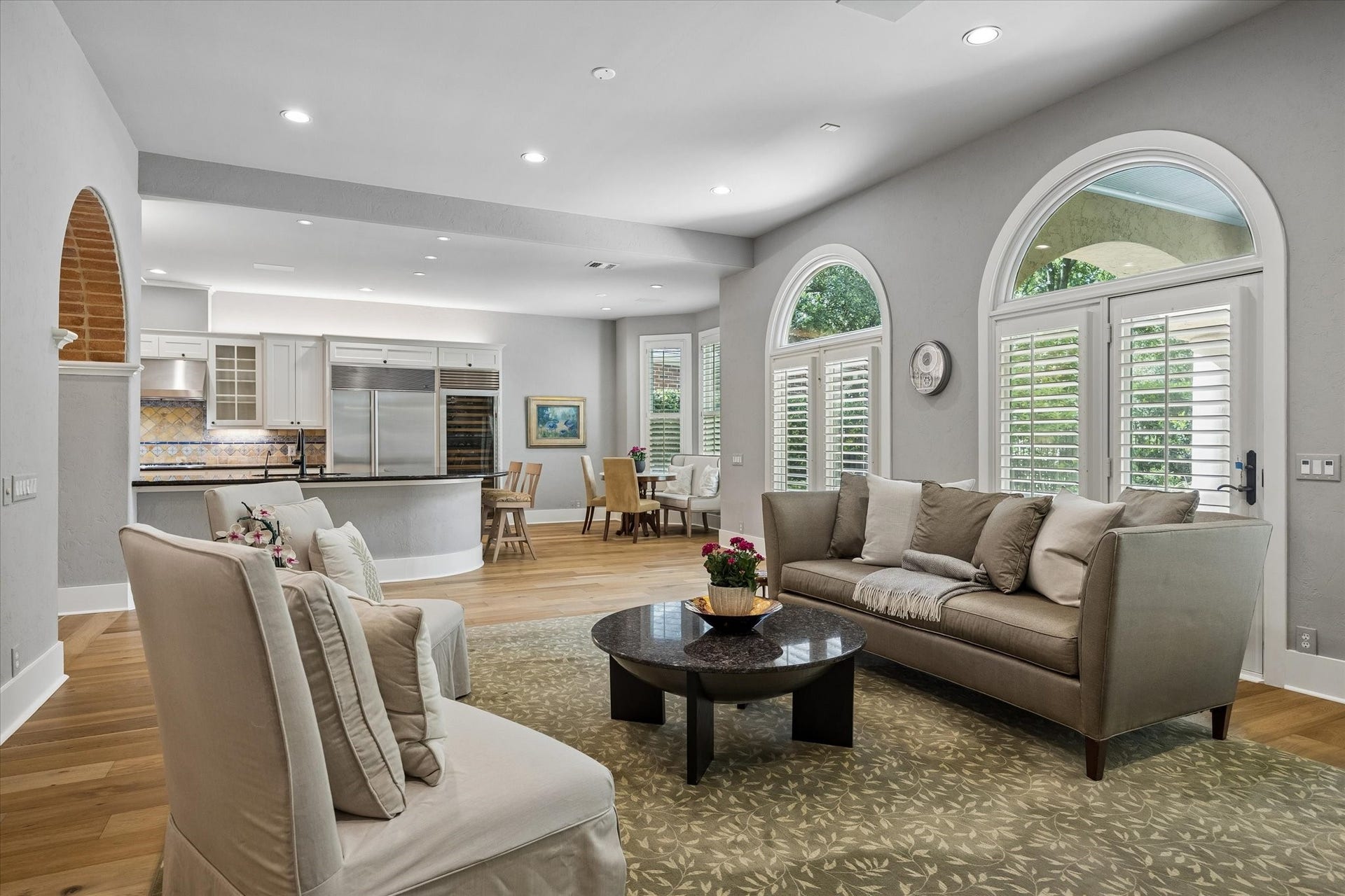 View from the family room into the breakfast room. Note the Palladian doors to the covered patio and sparkling pool.