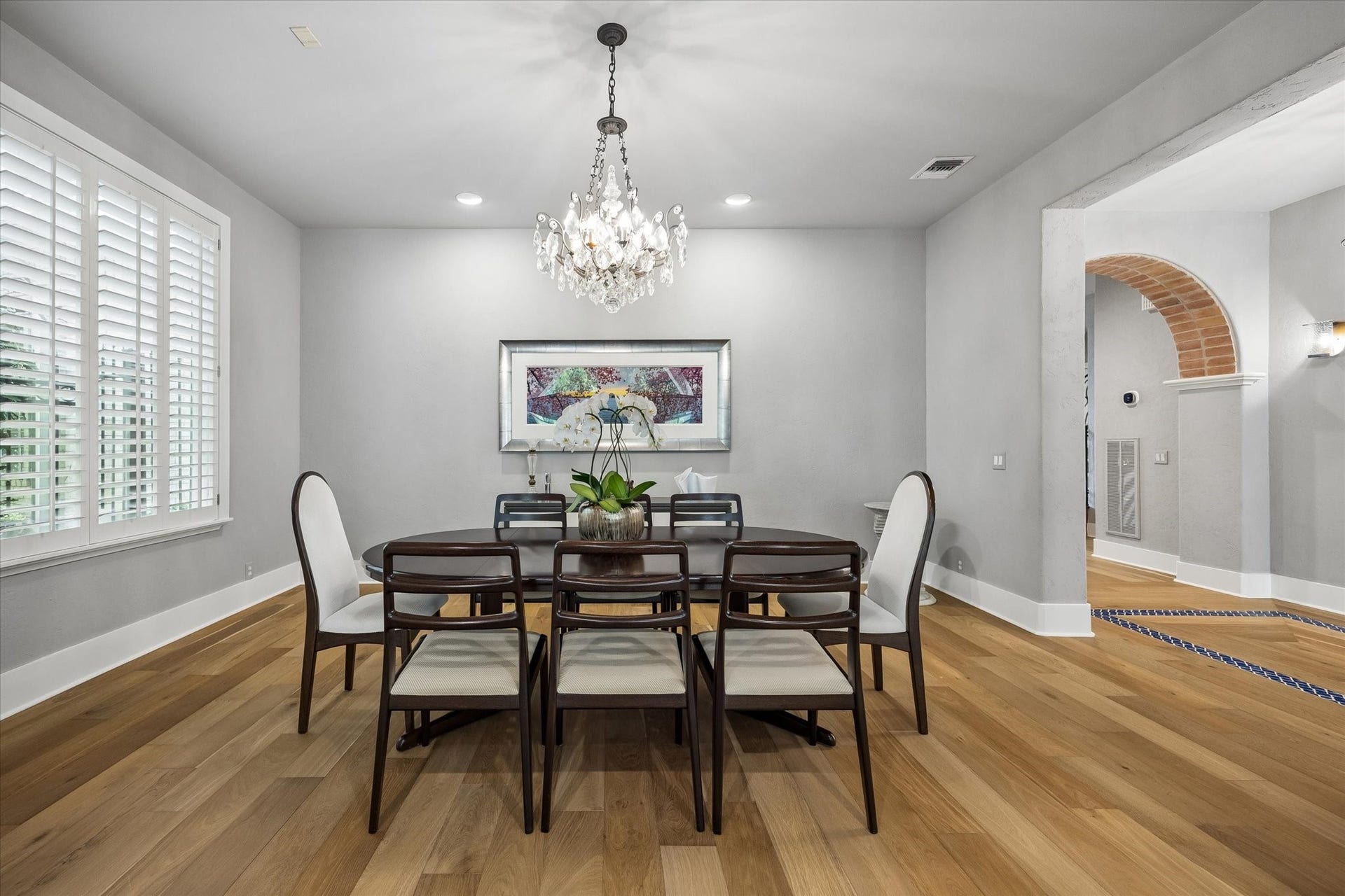 Formal dining room is spacious with oversized windows and plantation shutters.