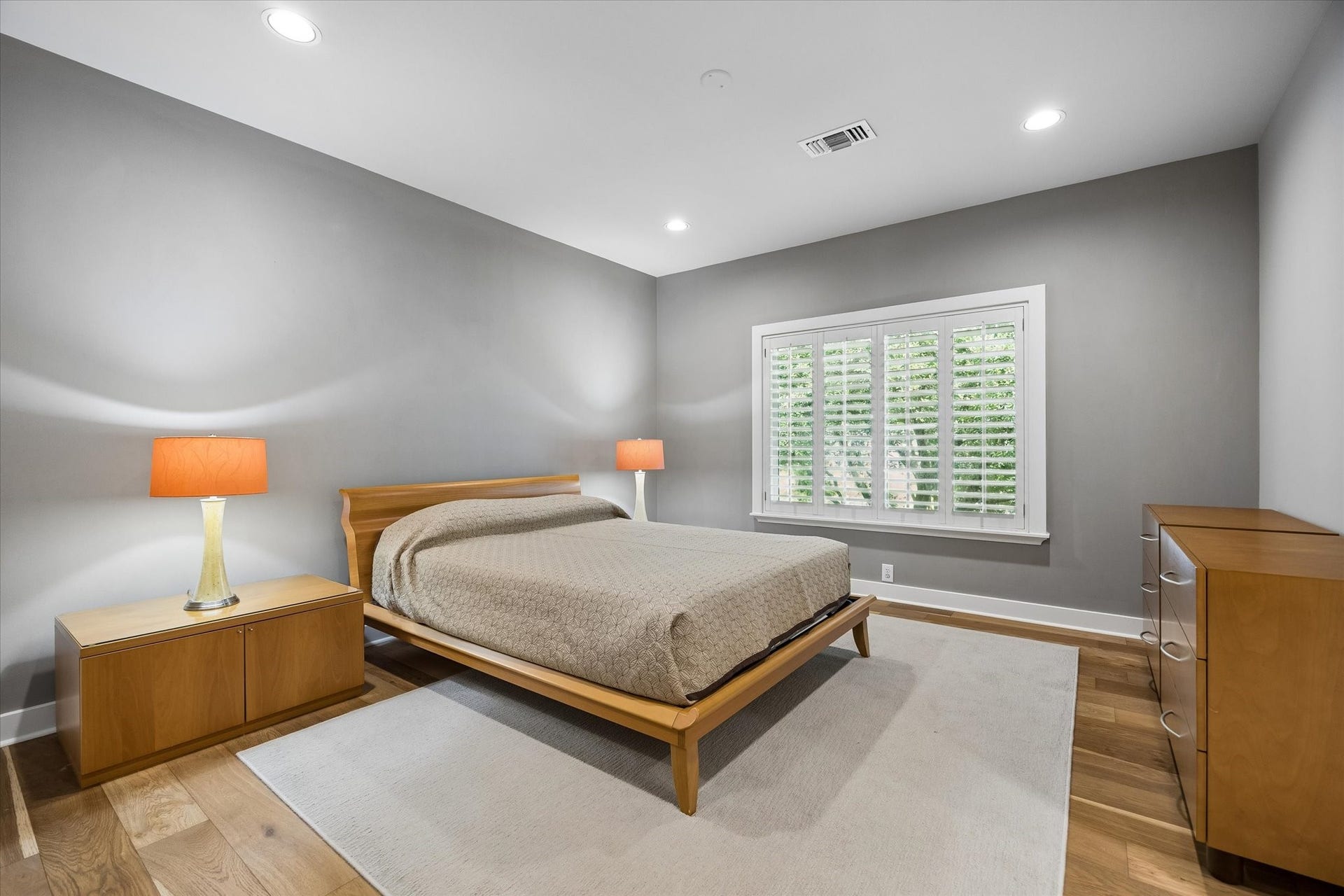 Secondary ensuite bedroom with hardwood floors.