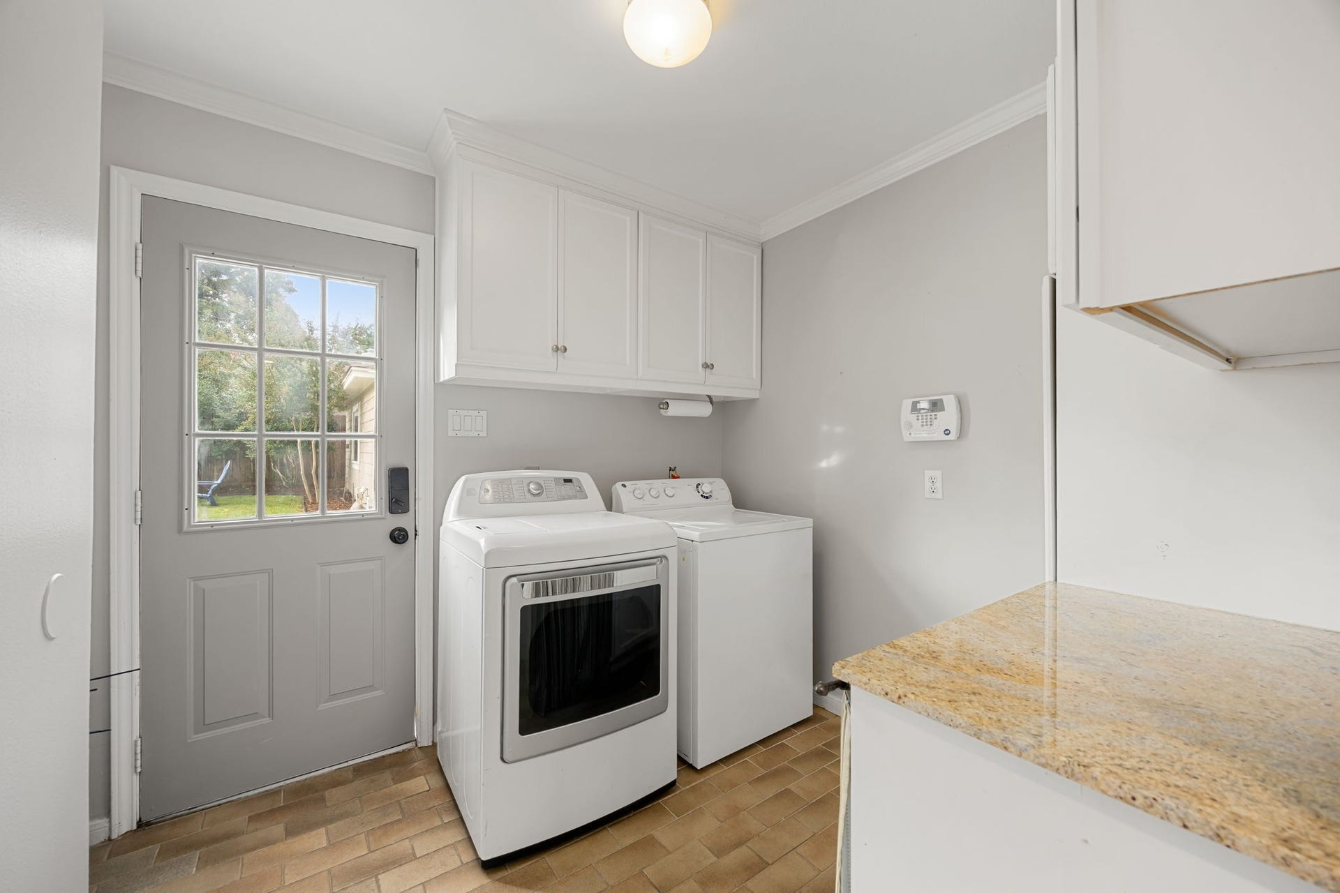 10831 Britoak Lane, Houston, TX 77079 Downstairs laundry room with a half-bath and leads out to the backyard.