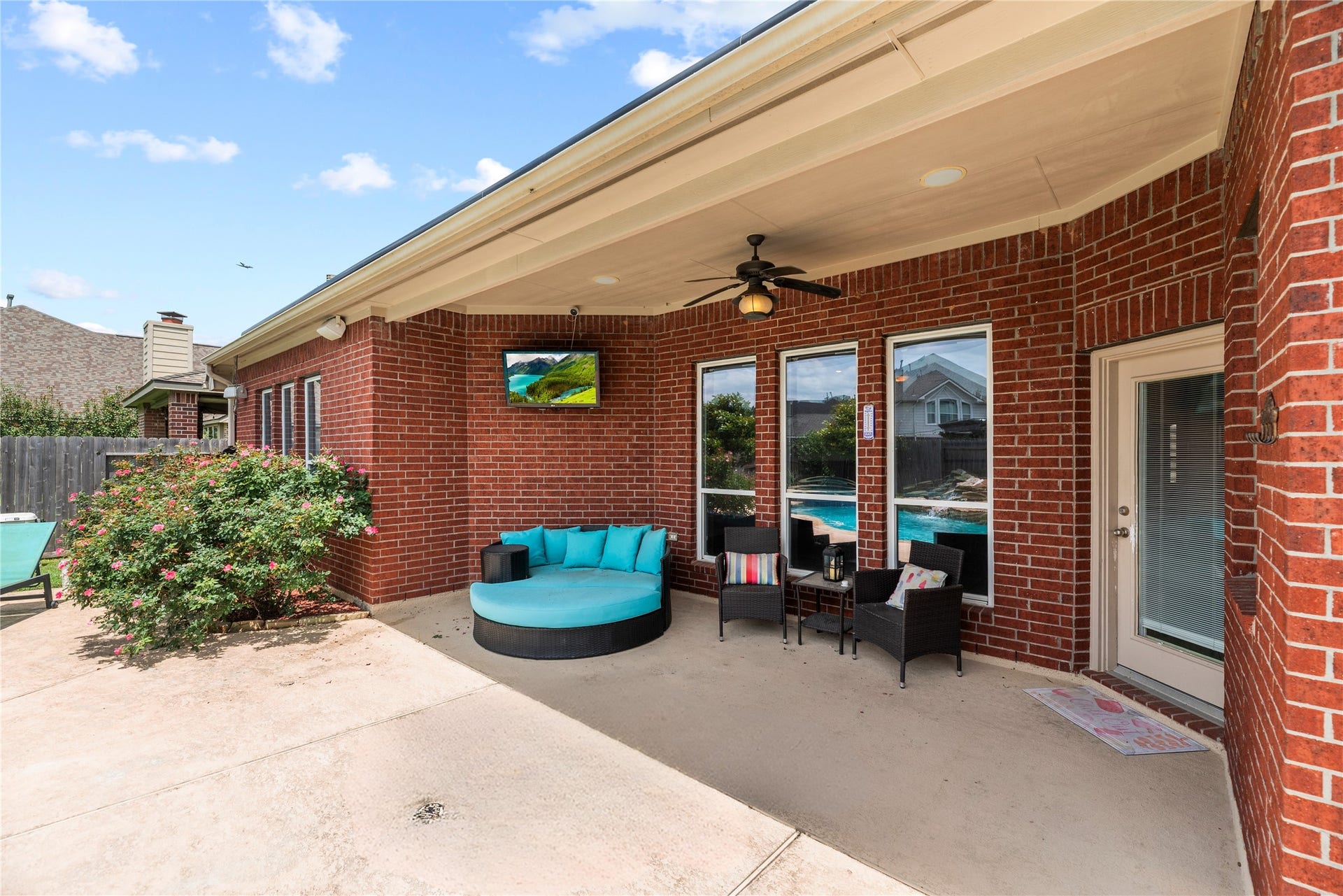3707 Cat Springs Lane, Missouri City, TX 77459 The rear patio serves as an outdoor living room, plumbed with a gas connection and perfectly situated for watching TV while enjoying the view of the pool.