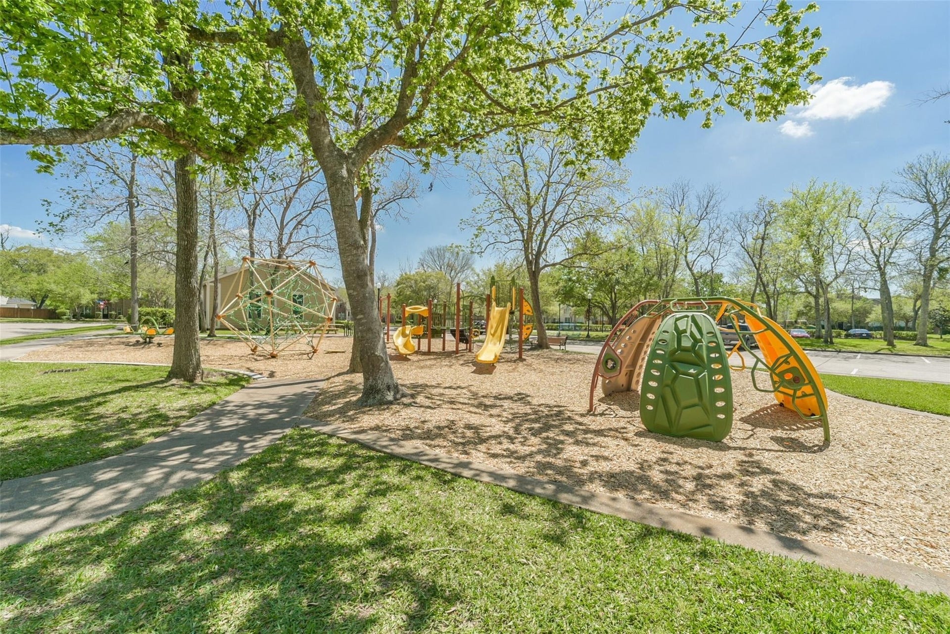 3707 Cat Springs Lane, Missouri City, TX 77459 Neighborhood park in Sienna featuring shaded green space and a playground, part of a master-planned community known for miles of trails, numerous parks, and outdoor recreation throughout Fort Bend County.