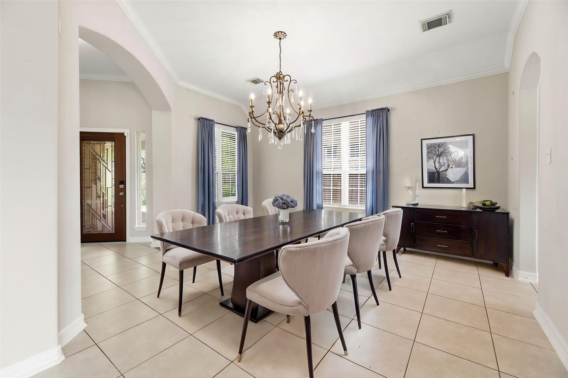 3707 Cat Springs Lane, Missouri City, TX 77459 The formal dining area sits conveniently off the foyer with high ceilings, crown molding, and elegant arched entryways that lead into the home's open-concept layout. A classic chandelier provides a sophisticated setting for intimate holiday meals or formal hosting. Virtually staged so you can imagine the possibilities.