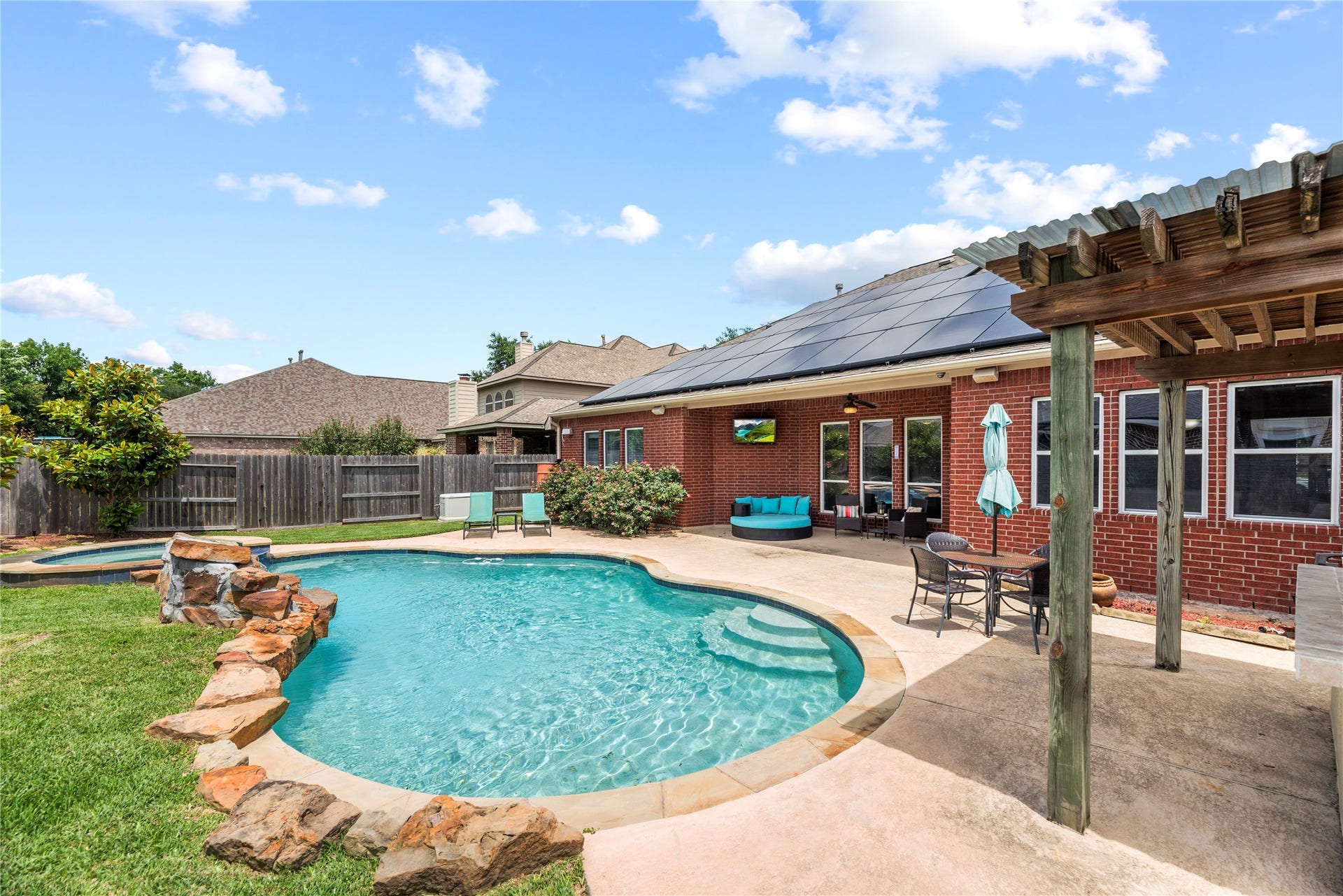 3707 Cat Springs Lane, Missouri City, TX 77459 The expansive backyard is a true oasis, anchored by an in-ground pool featuring a tranquil rock waterfall and integrated water features.