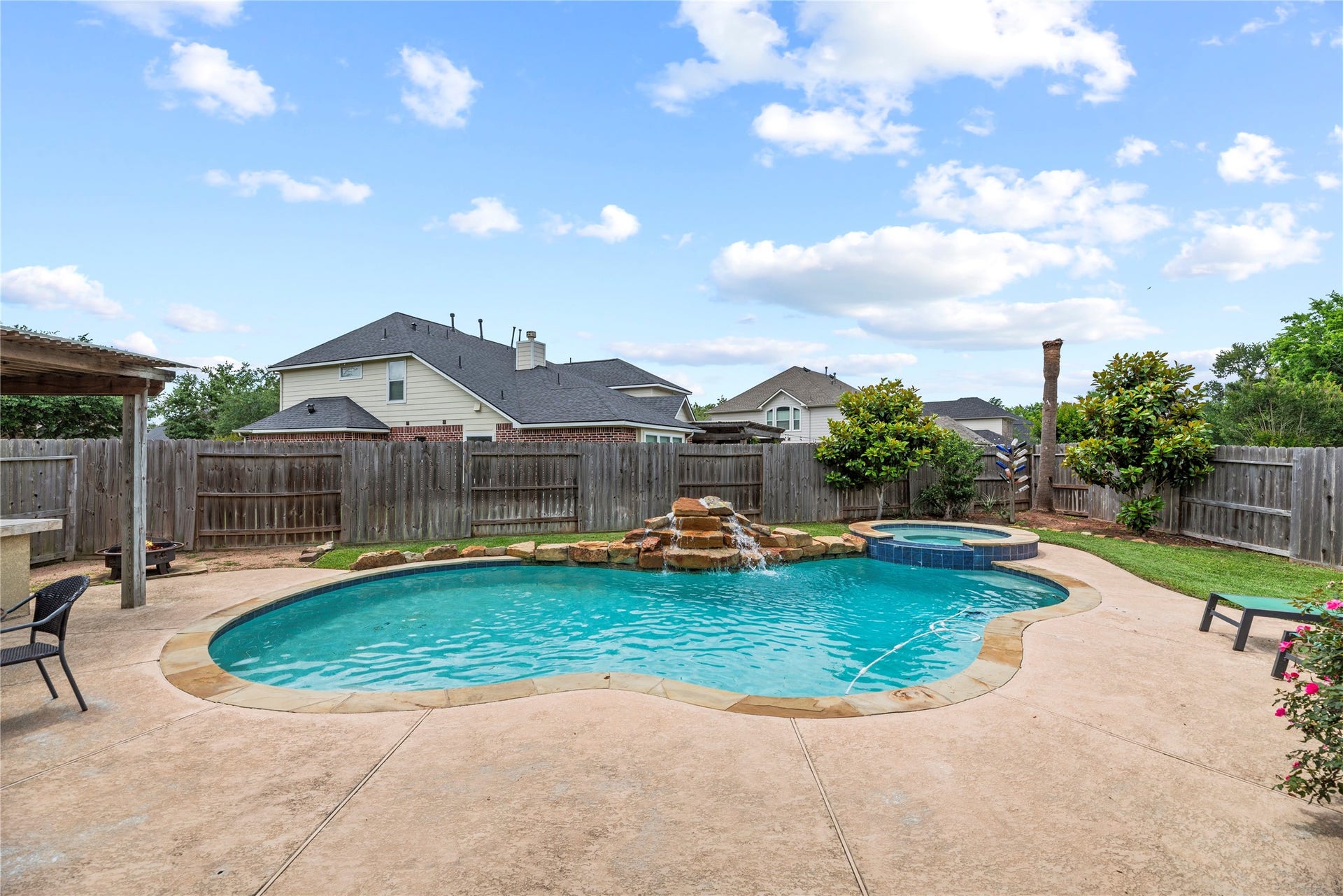 3707 Cat Springs Lane, Missouri City, TX 77459 This view highlights the seamless integration of the pool, lush landscaping, and professional-grade amenities that make this yard an entertainer's dream.