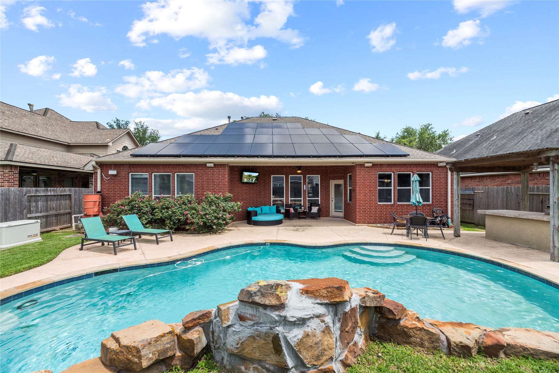 3707 Cat Springs Lane, Missouri City, TX 77459 Your private backyard oasis awaits, anchored by a sparkling pool and spa complete with tranquil water features. This resort-style space also includes a professional outdoor kitchen for the ultimate entertaining experience.