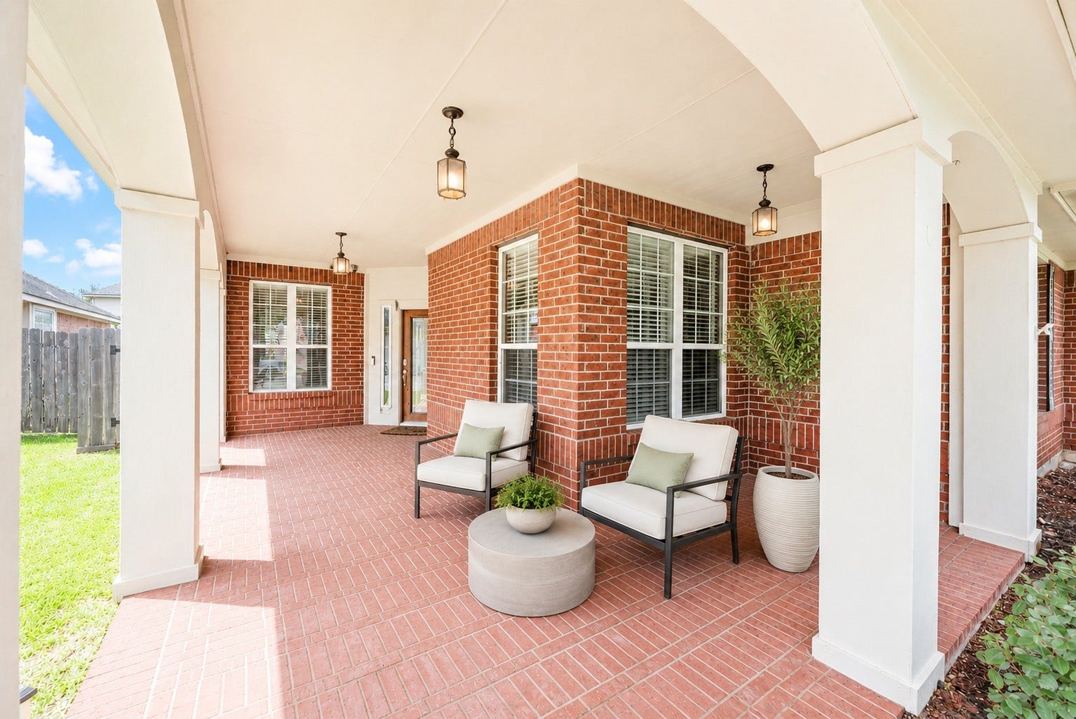 3707 Cat Springs Lane, Missouri City, TX 77459 The expansive brick-paved front porch provides a grand welcome, featuring soaring columns and elegant lighting that set a refined tone for this beautiful home. Virtually staged.