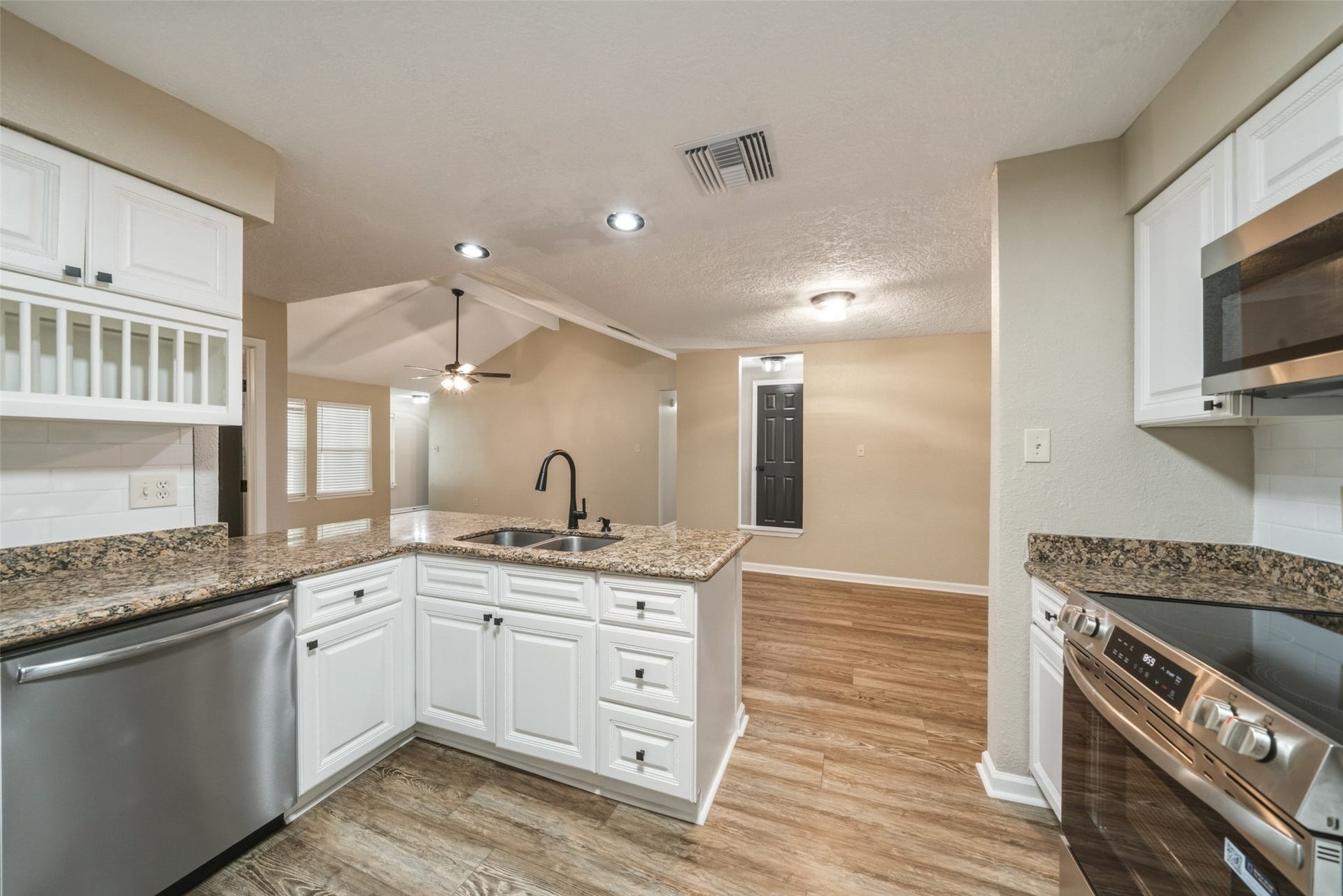 3200 Sand Reef Lane, League City, TX 77573 View of the kitchen from the door to the garage. The refrigerator is not in this picture but is included.
