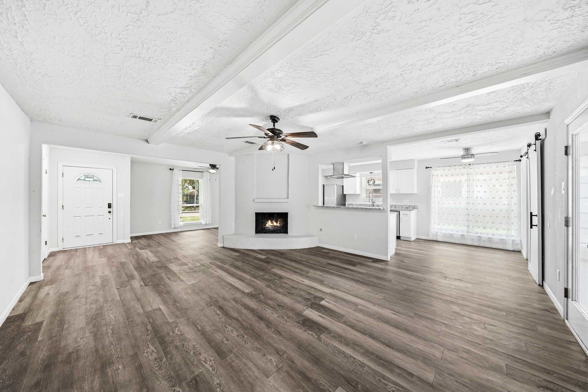 12010 Dorrance Lane, Meadows Place, TX 77477 This home has a spacious feel with the public rooms flowing into each other. The family room features a fireplace.