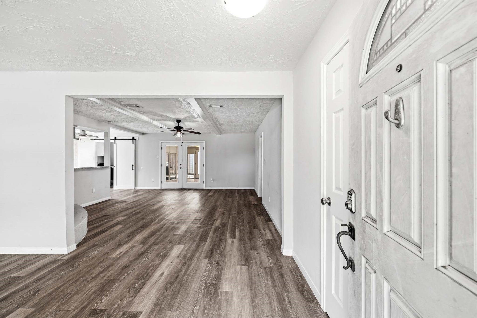 12010 Dorrance Lane, Meadows Place, TX 77477 As you enter, you see the spacious family room and the doors leading to the sunroom.