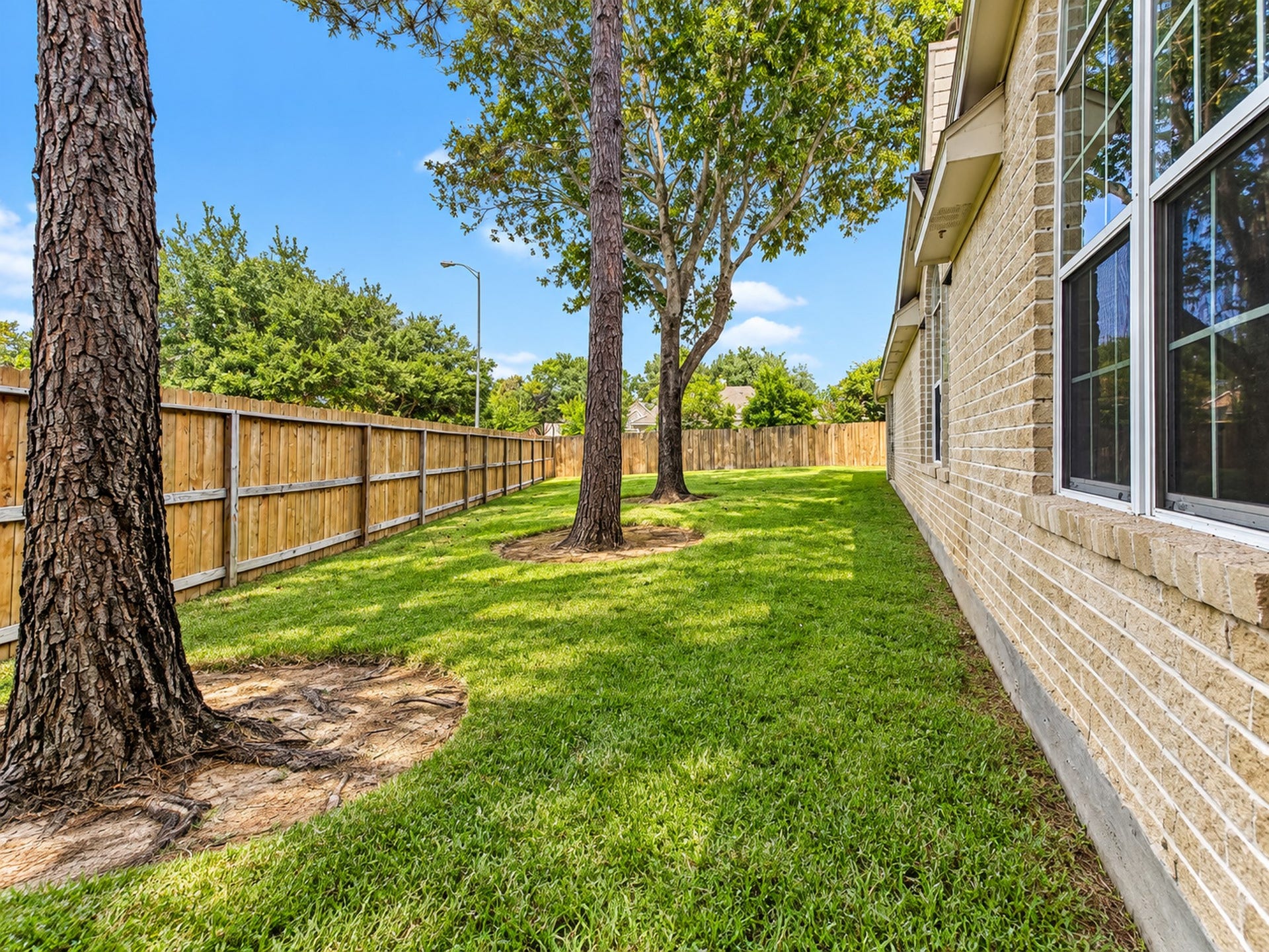 5810 Larch Leaf Lane, Richmond, TX 77469 A generous side yard adds even more usable outdoor space and showcases the benefits of this expansive corner-lot setting.