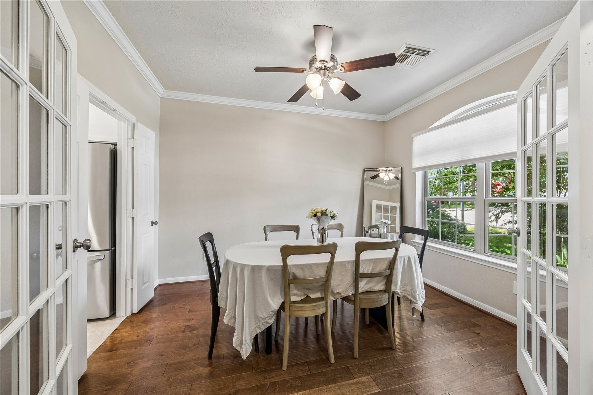 Alternate view of the dining room showing double doors leading to the front foyer.