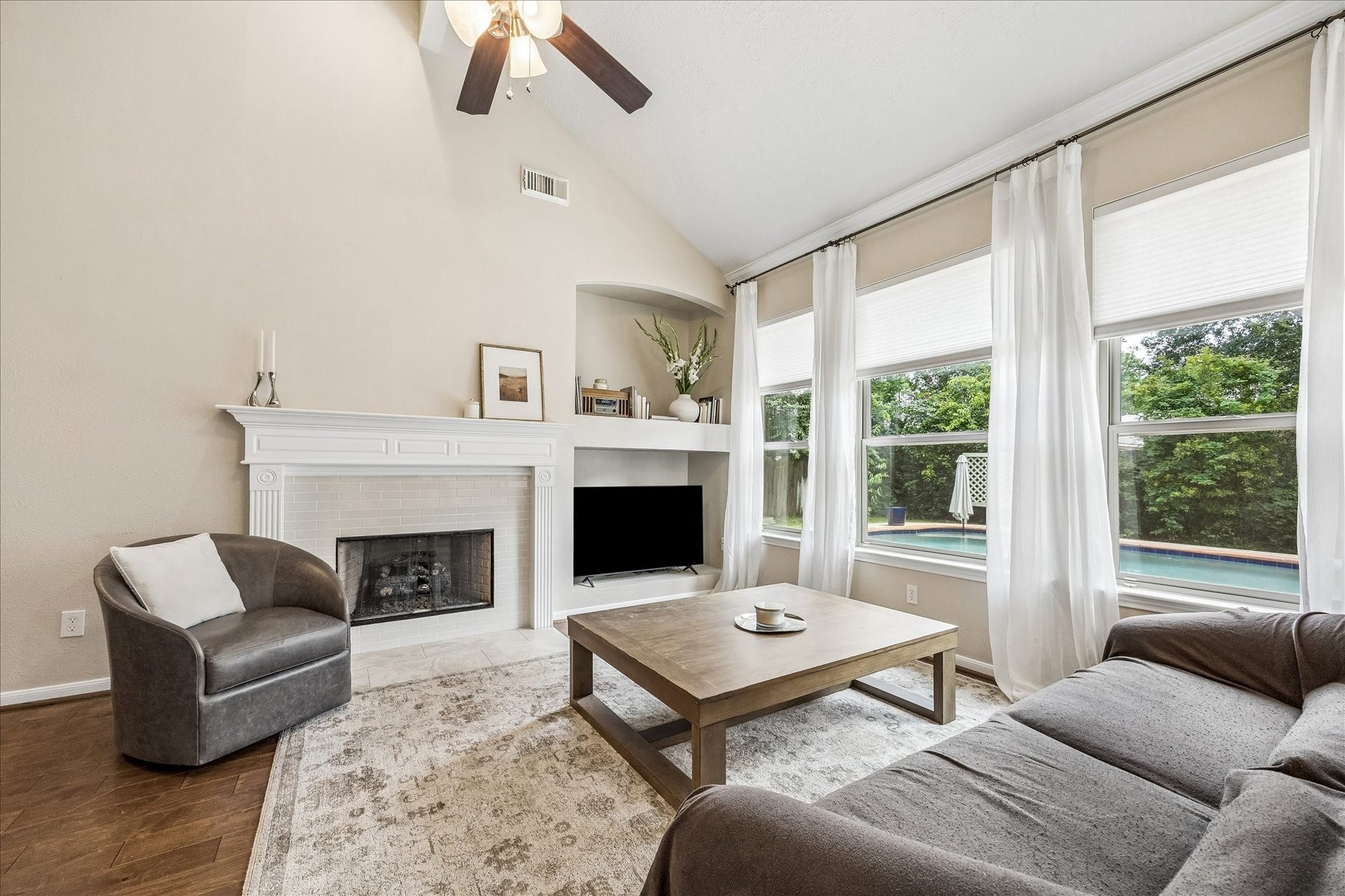 Bright, updated kitchen featuring crisp white cabinetry, quartz-style countertops, stainless steal appliances, and abundant workspace.