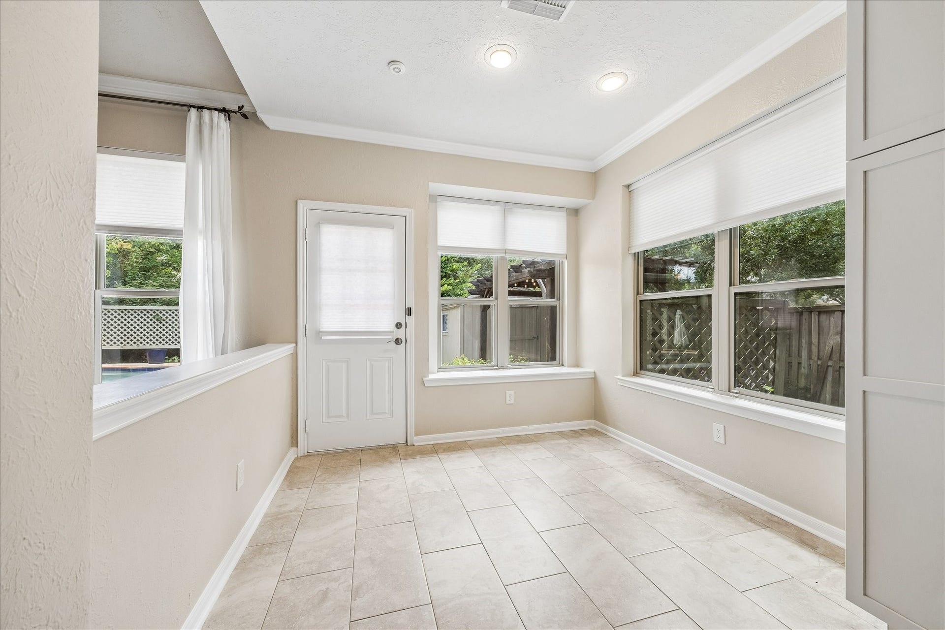 Grand entry foyer showcasing rich wood flooring and elegant staircase detailing.