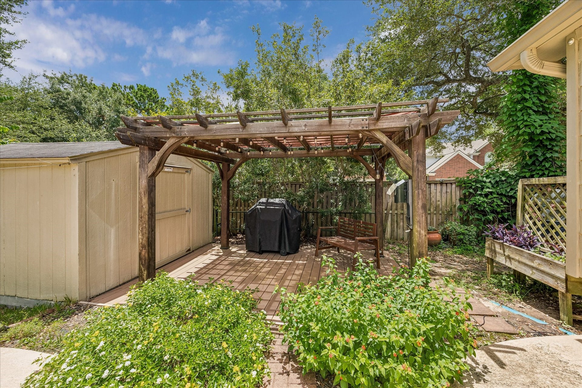 Classic two-story brick home nestled beneath mature shade trees, offering timeless curb appeal and a welcoming presence from the moment you arrive.
