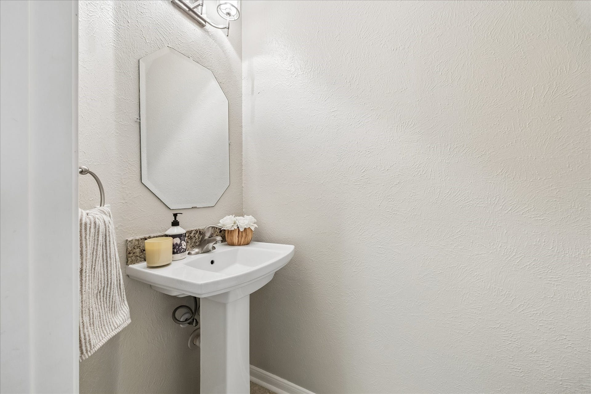 Spacious primary retreat with warm wood flooring, generous natural light, and peaceful views of the backyard.