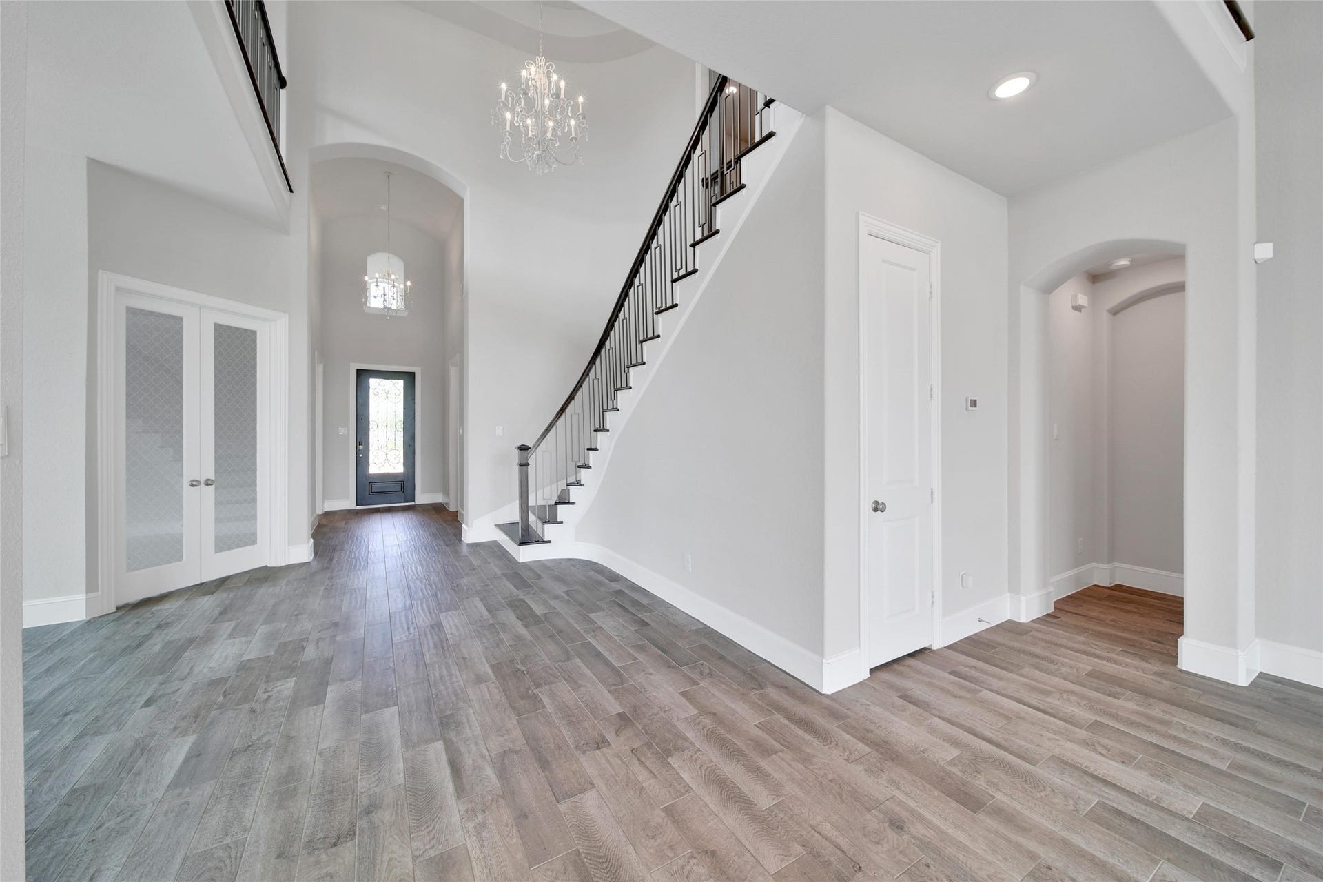23935 Birchwood Lake Lane, Katy, TX 77493 The stunning foyer, with its soaring ceiling, elegant chandelier and curved staircase, creates a striking focal point the moment you step inside.