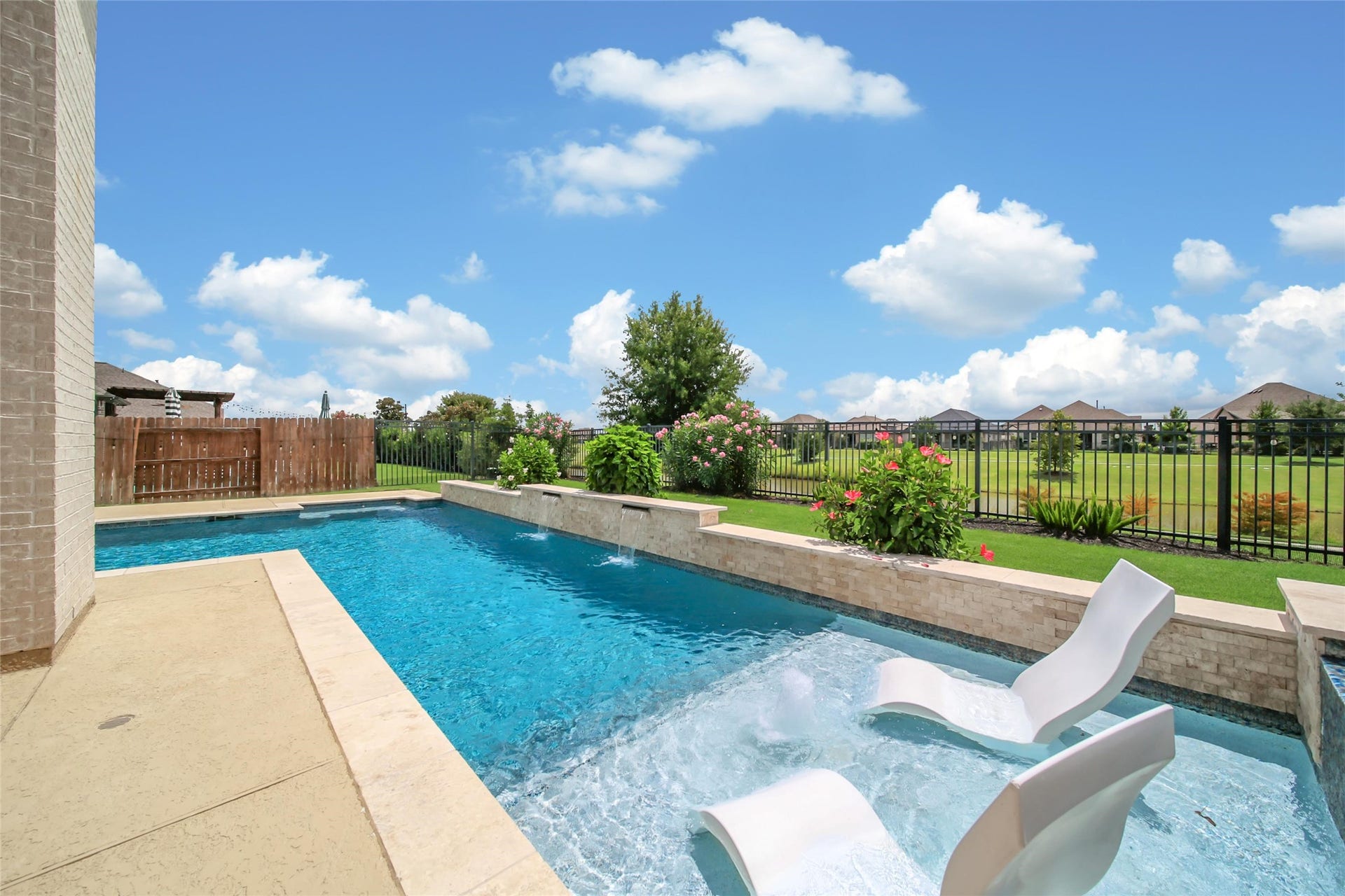 23935 Birchwood Lake Lane, Katy, TX 77493 Designed for luxury, this backyard features a resort worthy heated pool with a sun shelf framed by "ledge loungers". The pool and spa can be controlled remotely with Hayward app.