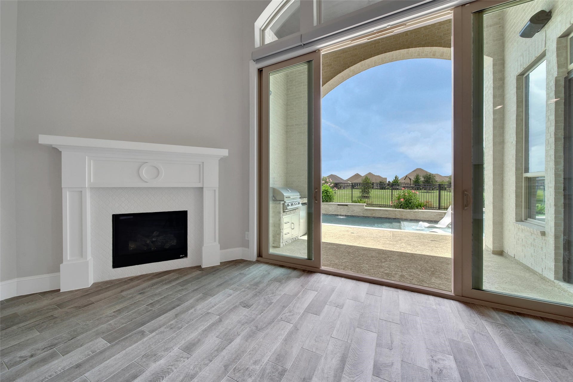23935 Birchwood Lake Lane, Katy, TX 77493 Living room sliders open wide to expand the entertainment space, effortlessly blending indoor comfort with outdoor living. Automatic shades ($3K Upgrade) help control the amont of sunlight that filters into the home.