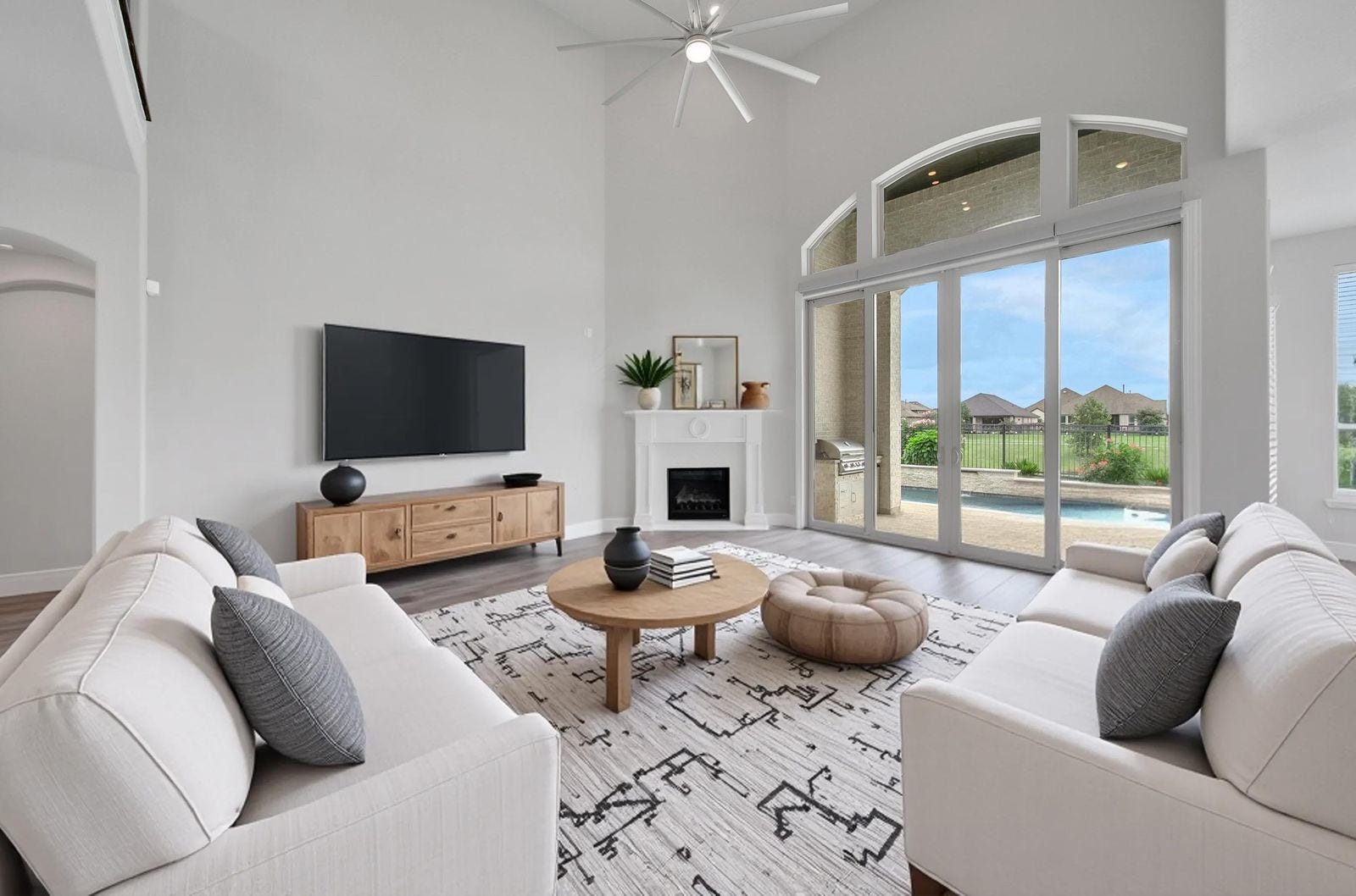 23935 Birchwood Lake Lane, Katy, TX 77493 The spacious living area offers serene views of the backyard pool and the peaceful lake beyond.
