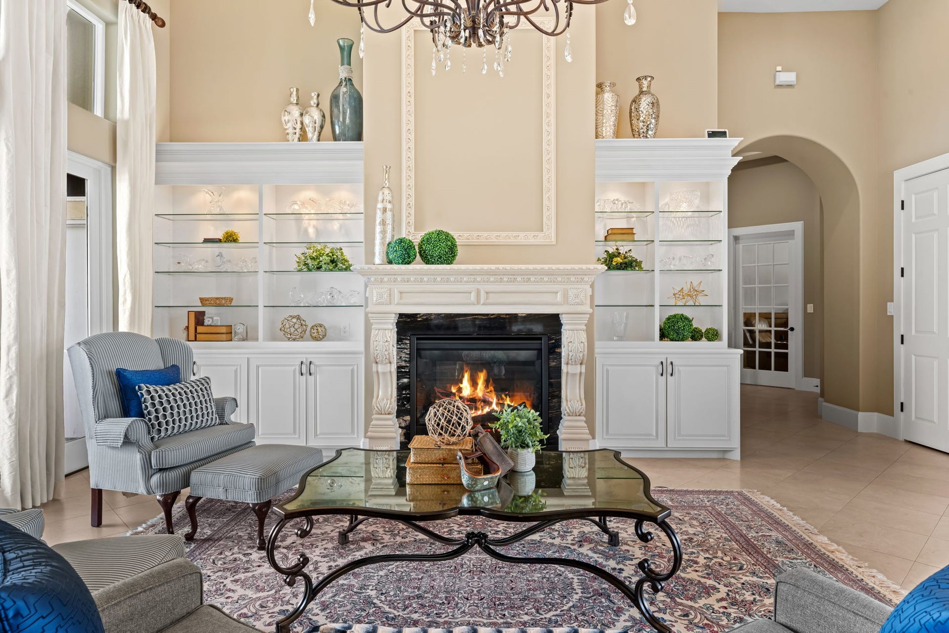8145 Fm-1462, Rosharon, TX 77583 The formal living room features a gas fireplace and custom built-ins. The French doors lead out to the patio and sitting area with views of the pond.