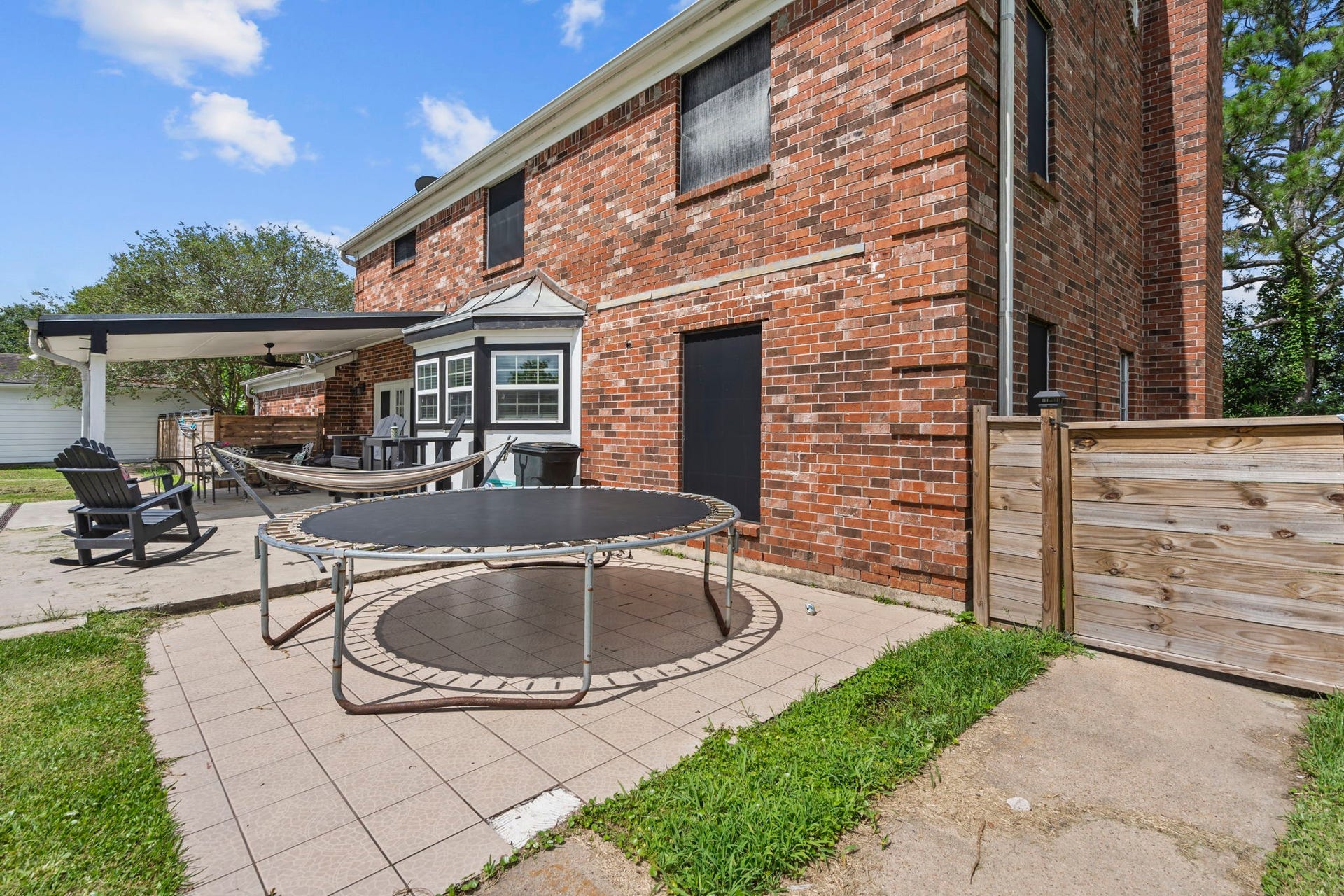 7009 Avenue R, Santa Fe, TX 77510 Extra patio space for lots of games.