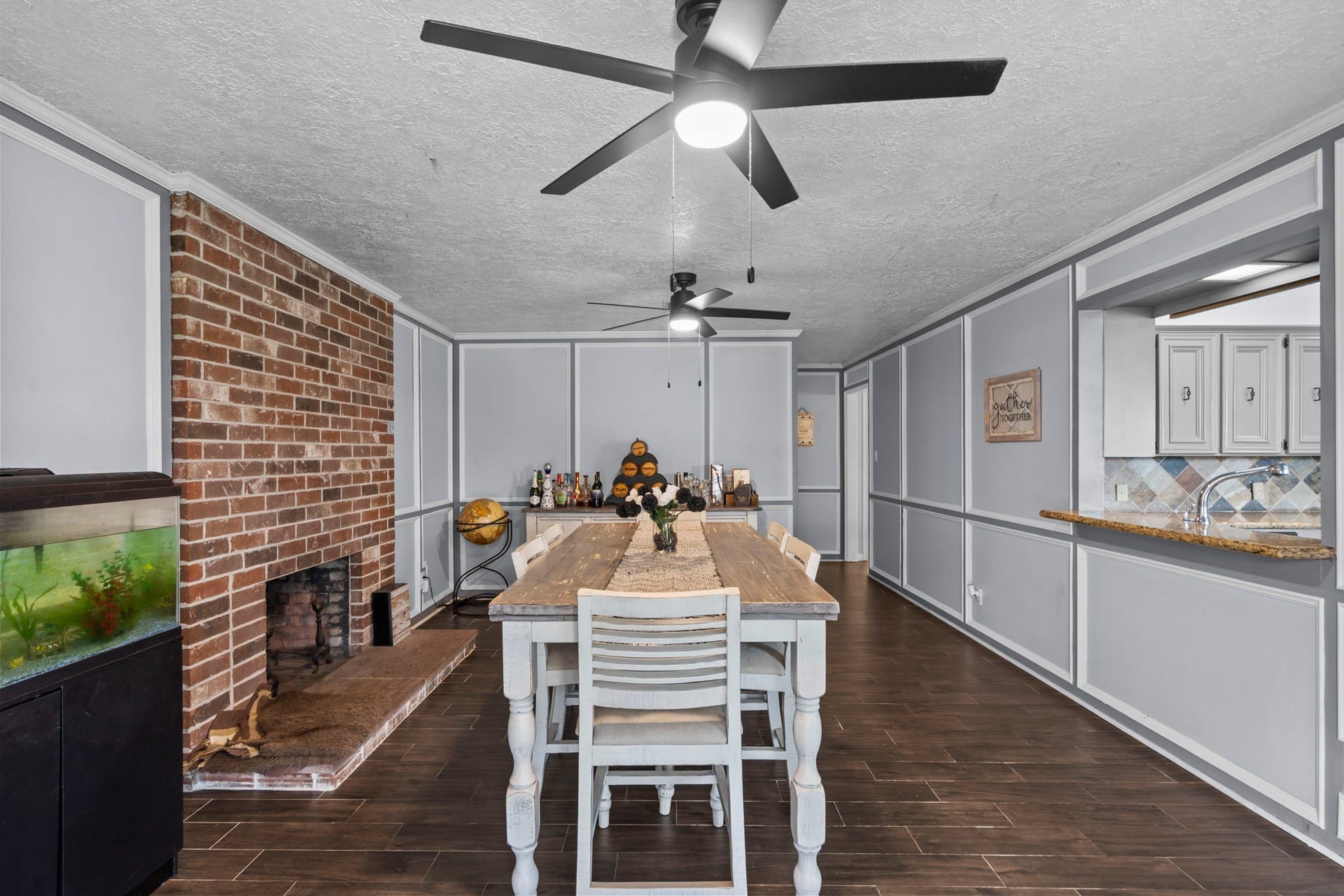 7009 Avenue R, Santa Fe, TX 77510 Beautiful dining room with exposed brick fireplace.