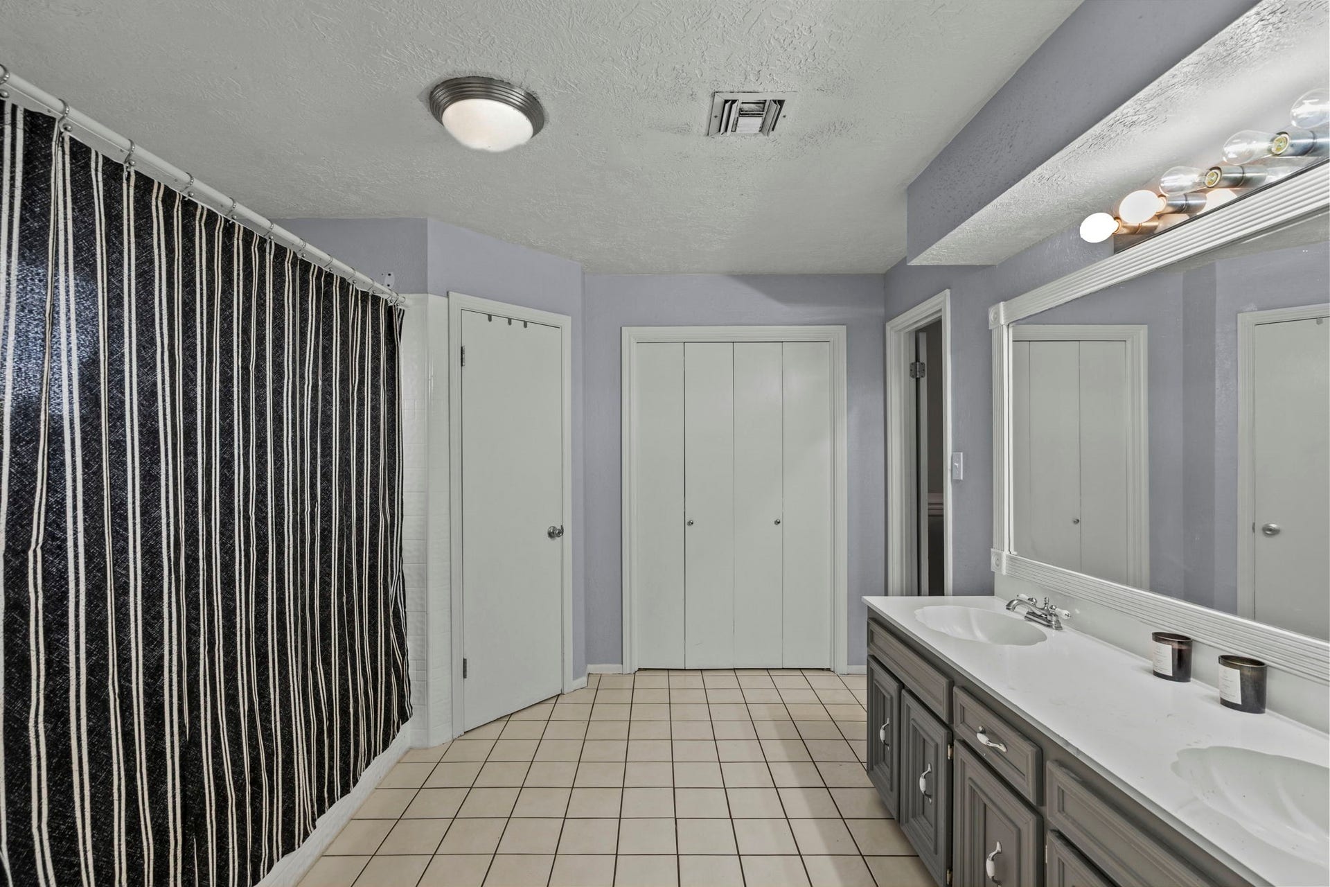 7009 Avenue R, Santa Fe, TX 77510 Primary bathroom with double sinks and plenty of storage.