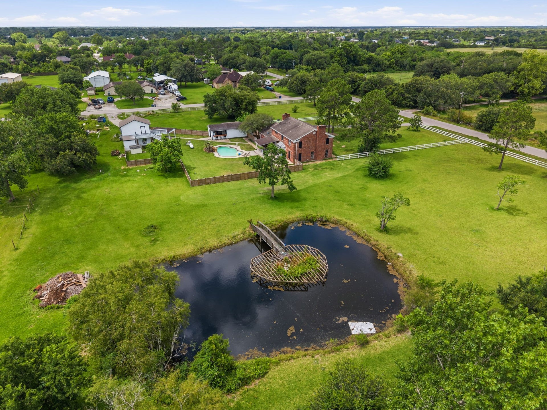 7009 Avenue R, Santa Fe, TX 77510 Property is fenced and cross fenced. Pond area has a bridge for fishing!