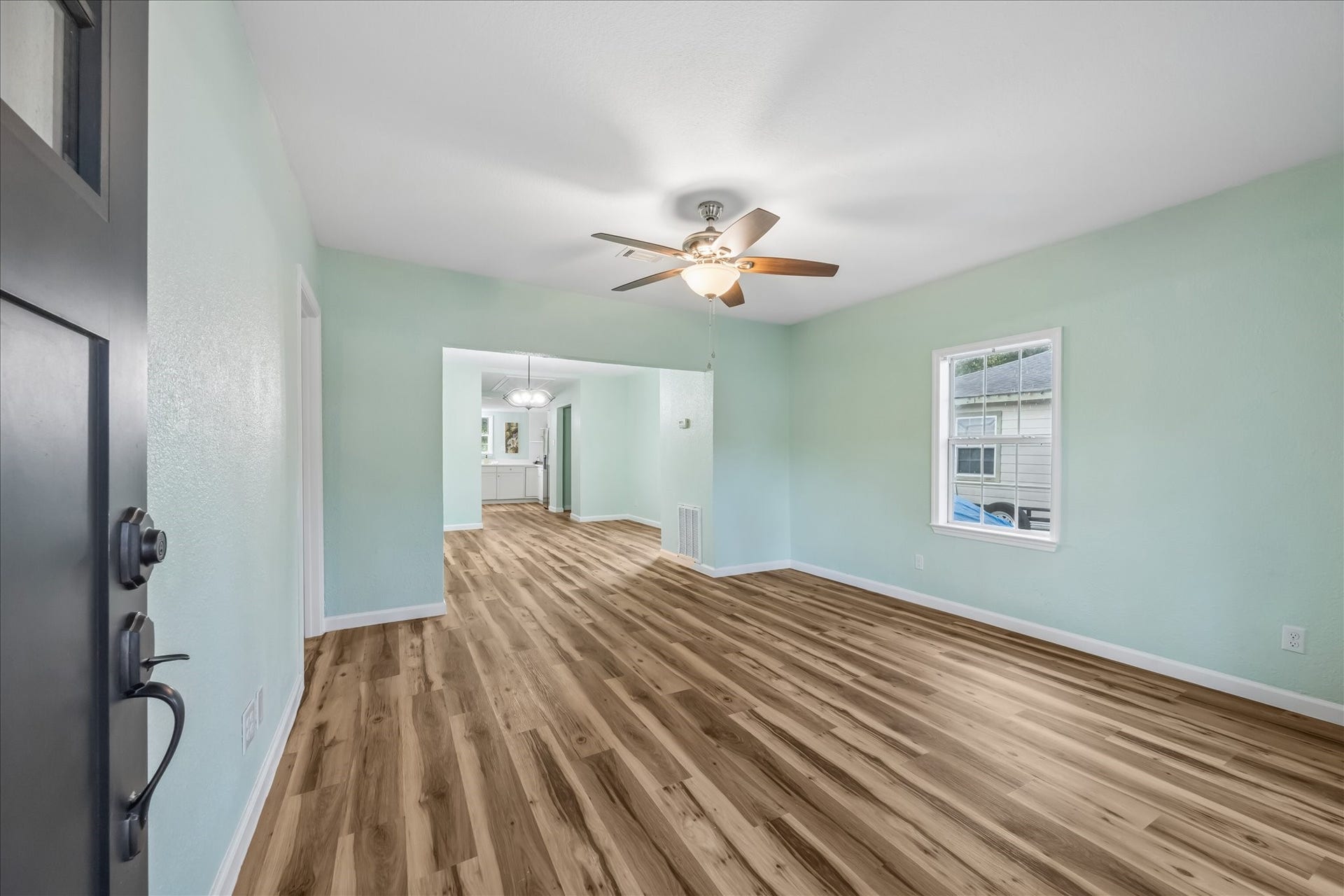 5122 Avenue L, Santa Fe, TX 77510 Bright living room with new LVP flooring and fresh paint.