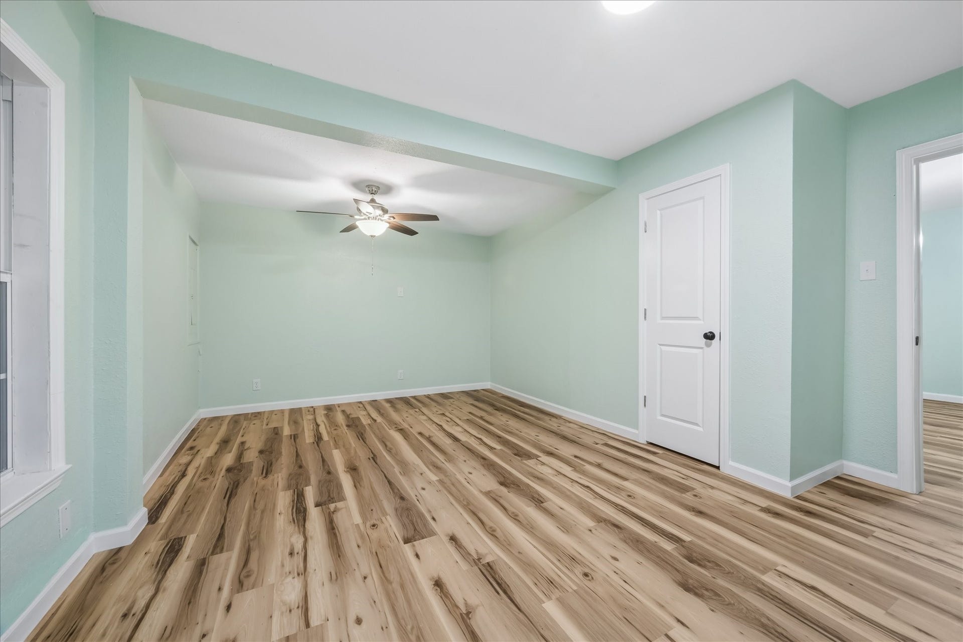 5122 Avenue L, Santa Fe, TX 77510 Light-filled bedroom with fresh paint and new flooring.