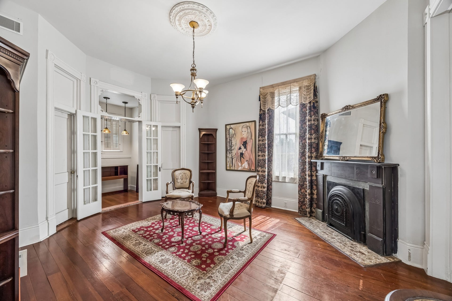 1818 Broadway Street, Galveston, TX 77550 Upon entering, you see the library on your left. The fireplace is one of three original fireplaces in the home that once burned coal to provide heat. A dry bar area hides behind the French doors.