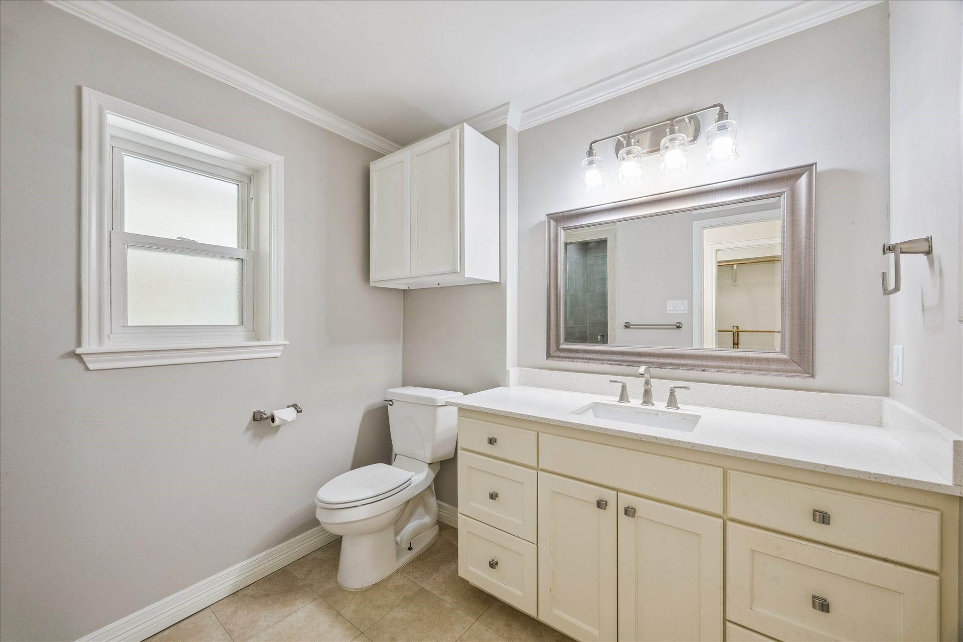 12511 Britt Road, Pearland, TX 77584 Primary bath with matching quartz counter, brushed stainless fixtures and tile flooring.