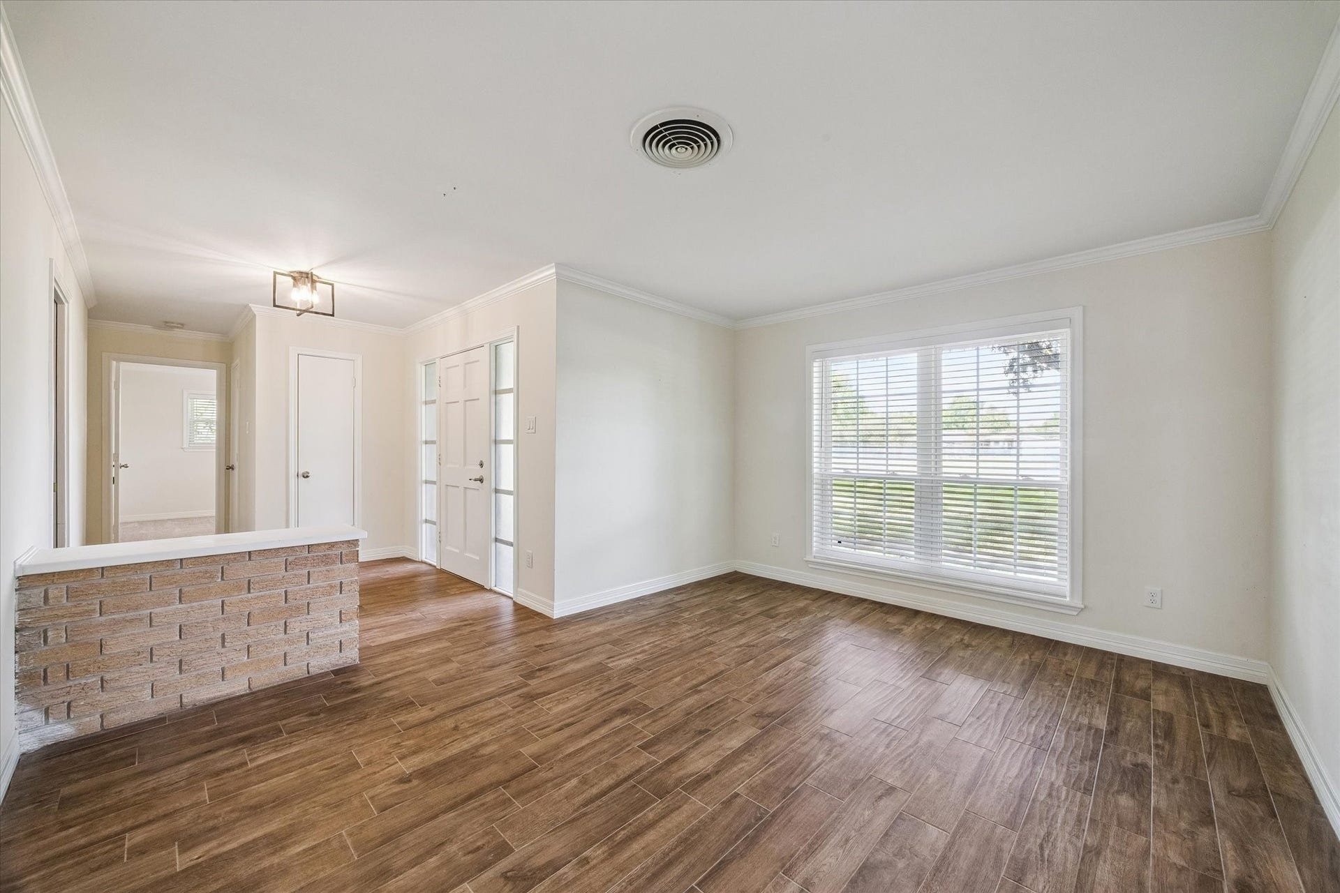 12511 Britt Road, Pearland, TX 77584 Crown molding (located throughout the home) and bricked pony wall make the formal living room stand out.