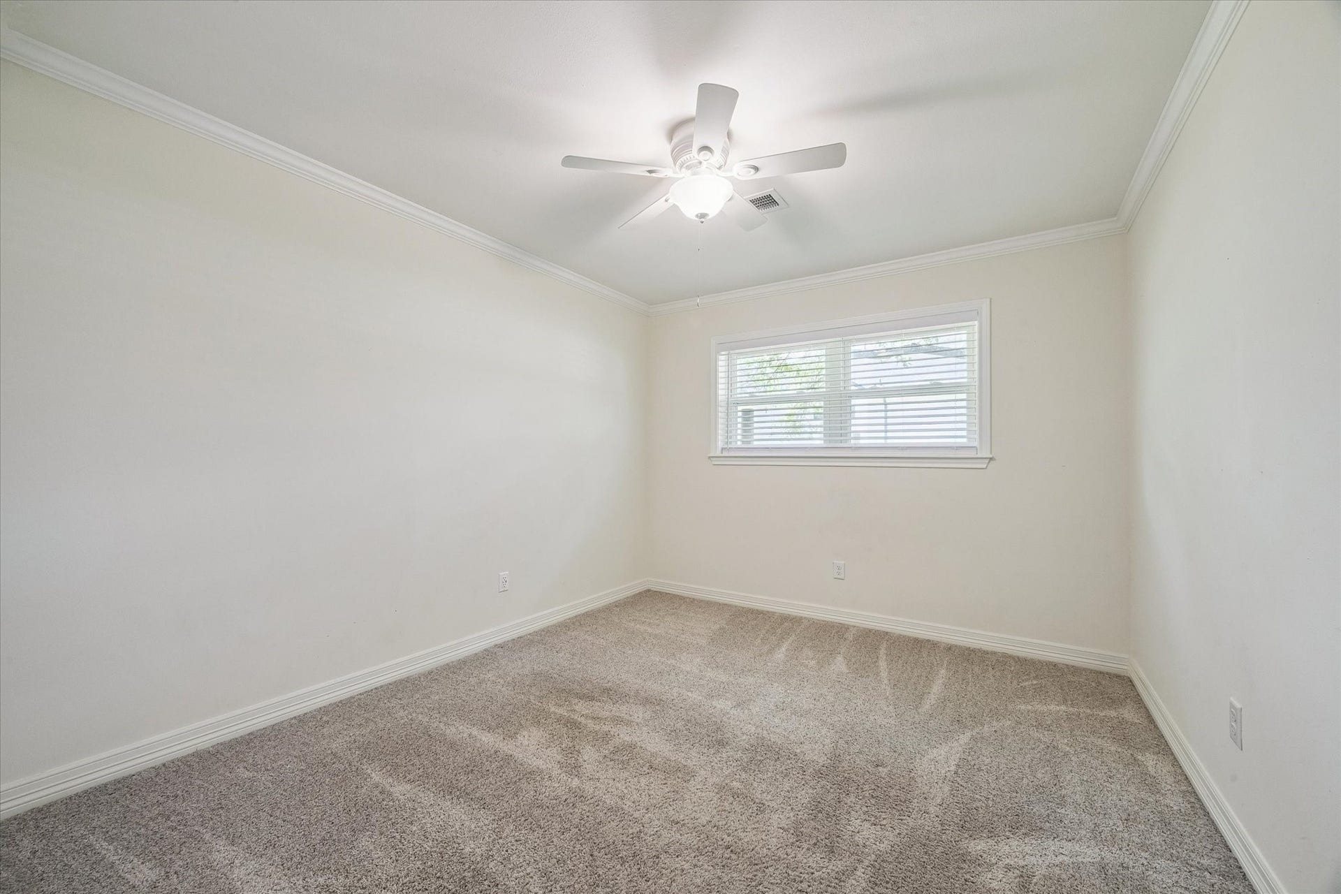 12511 Britt Road, Pearland, TX 77584 Bedroom 3 with ceiling fan looks upon the side yard.