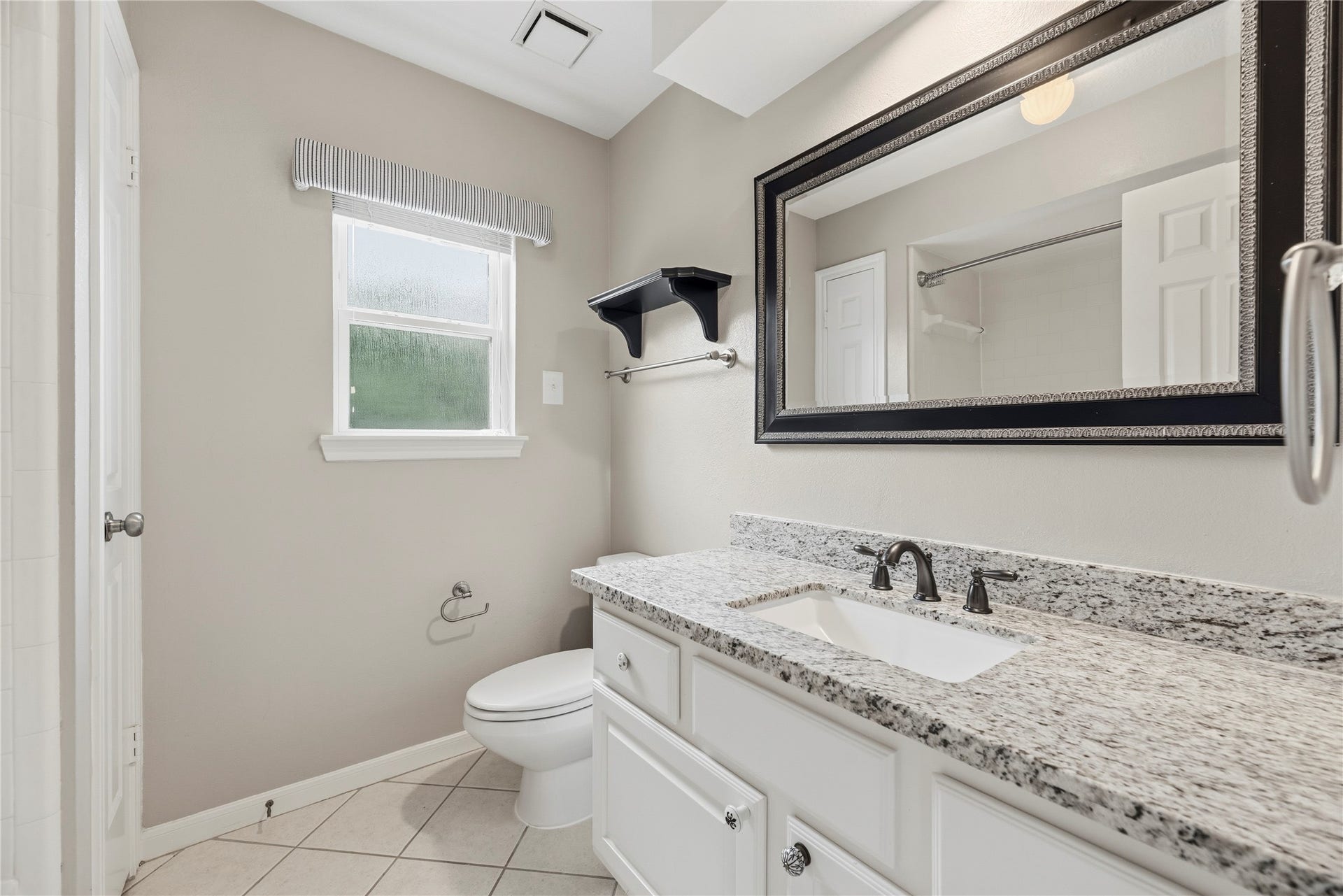 Bathroom #3 features granite countertops and a shower/tub combo.