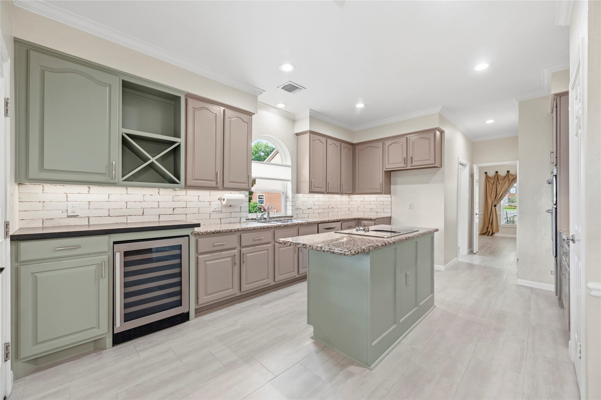 The custom cabinetry features a built-in wine fridge and undercabinet lighting that adds a modern, functional touch.