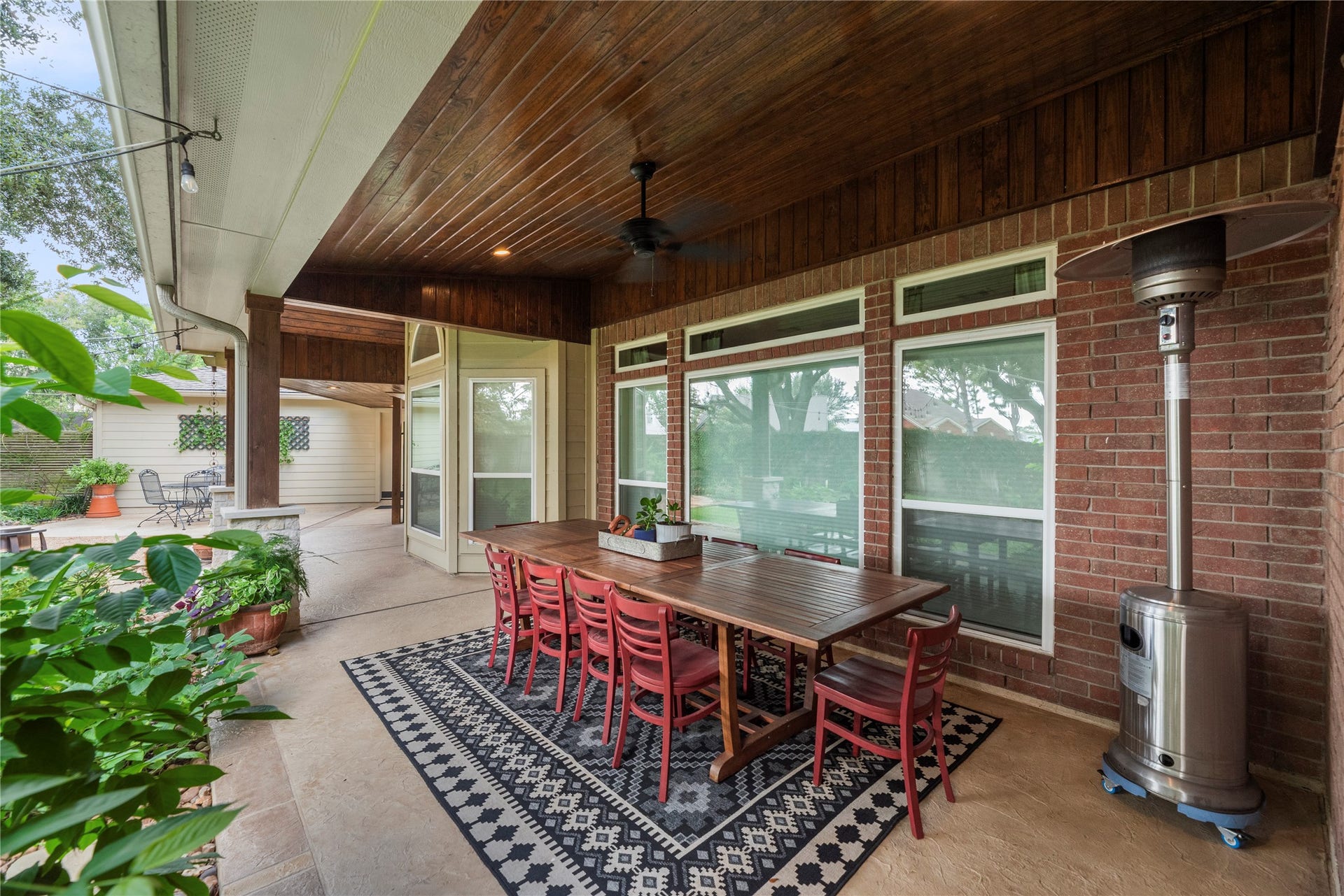 The custom covered patio with rich wooden ceiling includes a large outdoor dining area. An entertainer's dream!