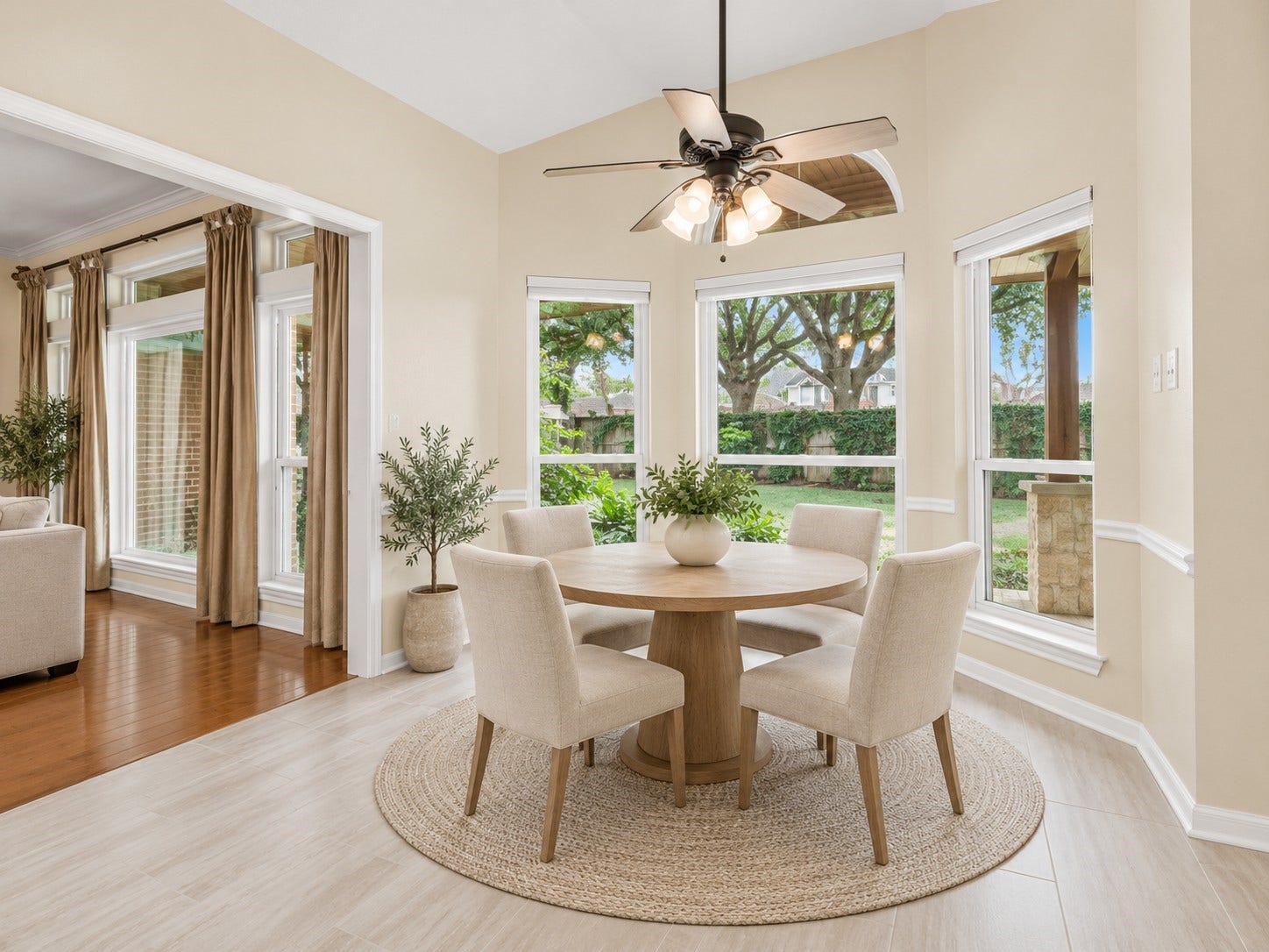 Bright and inviting breakfast nook featuring elegant tile flooring and bay windows. *virtually staged