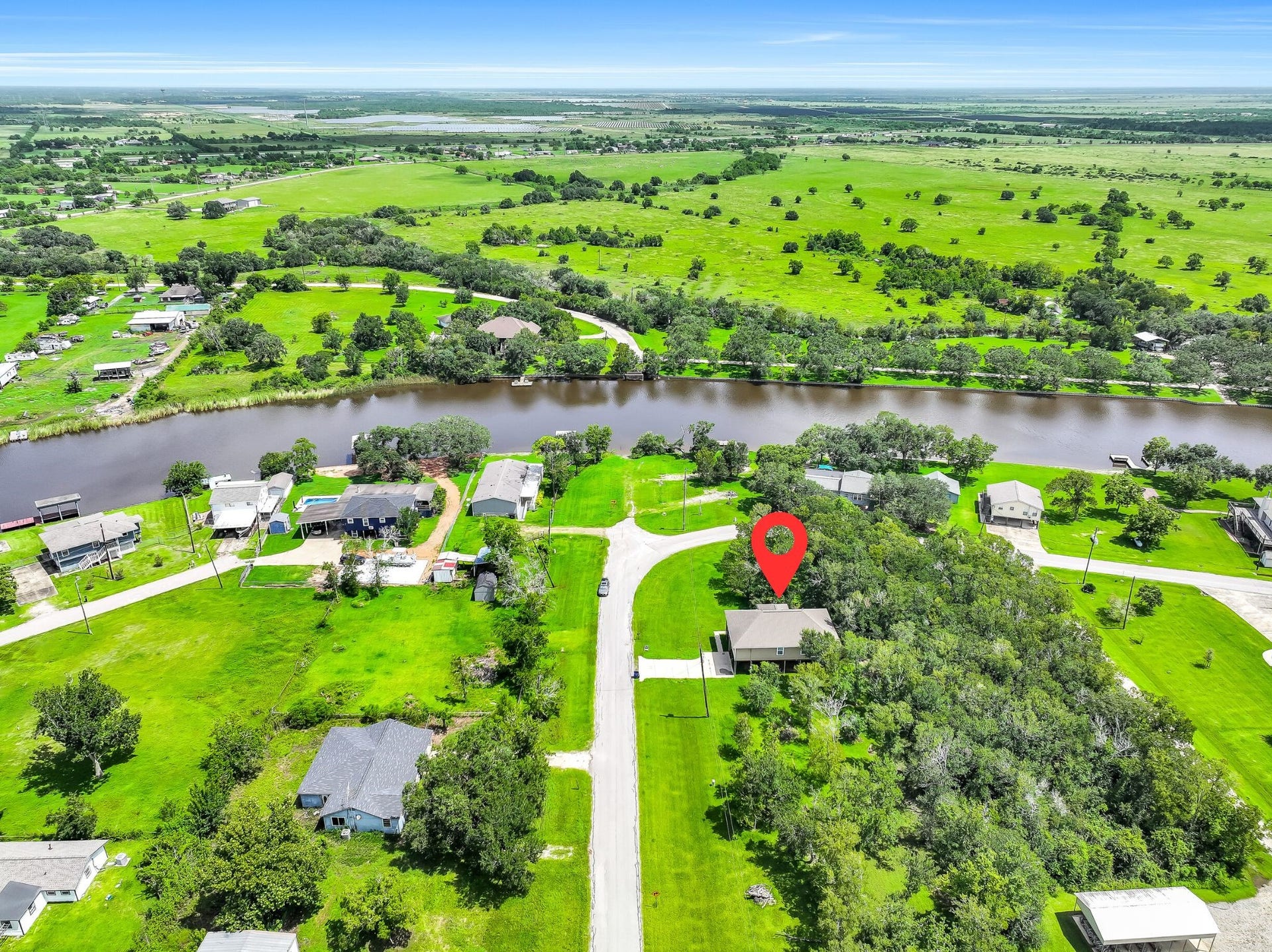 11930 Bastrop Beach Road, Angleton, TX 77515 From above, it's easy to appreciate the generous homesite surrounded by mature trees, neighboring acreage, and the winding waters of Bastrop Bayou. It's the kind of setting that's becoming increasingly difficult to find.