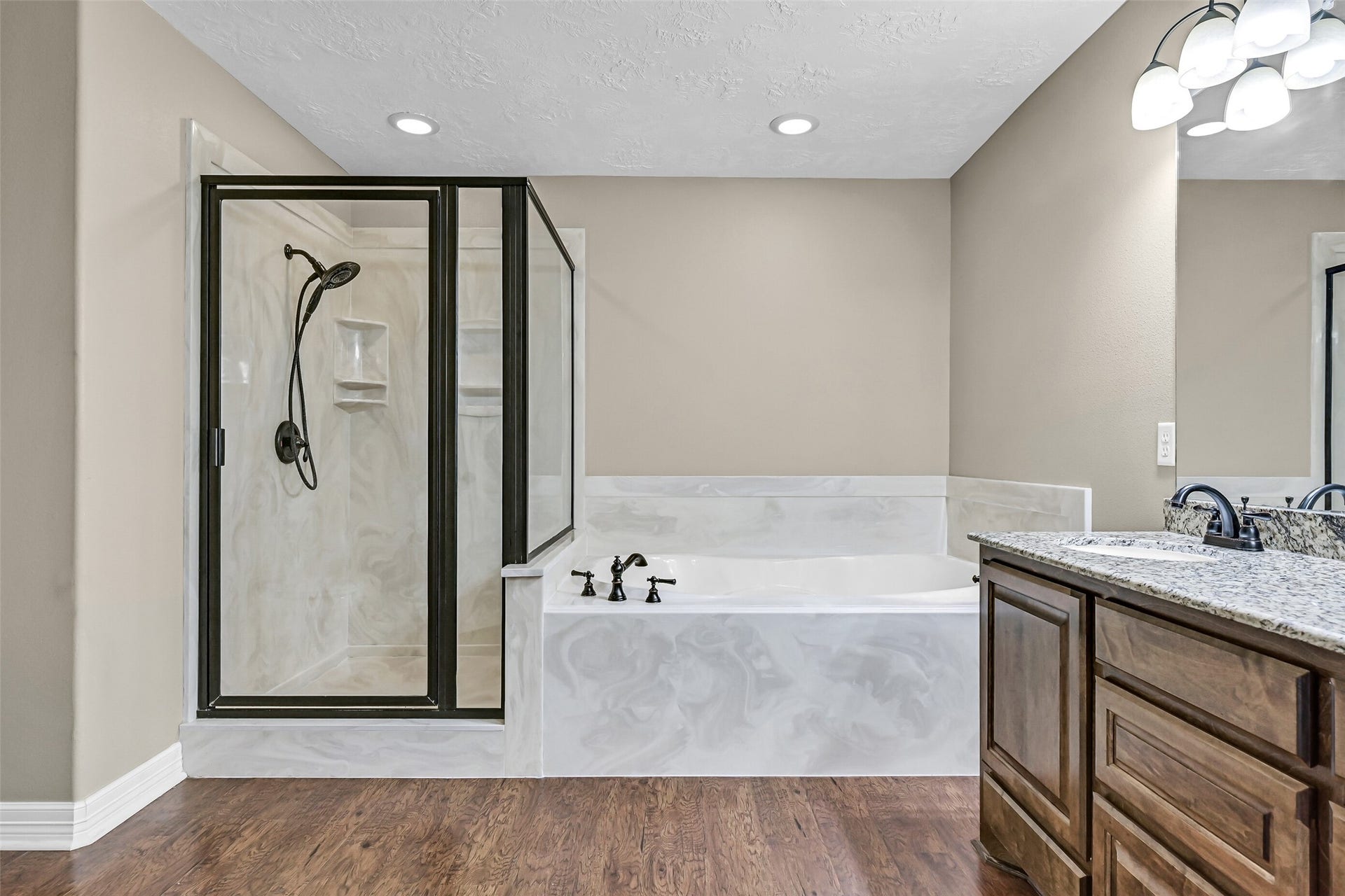 11930 Bastrop Beach Road, Angleton, TX 77515 Unwind after a day on the bayou in the oversized soaking tub or refresh in the separate walk-in shower. Granite countertops, custom cabinetry, and quality finishes continue the home's thoughtful design throughout the primary bath.