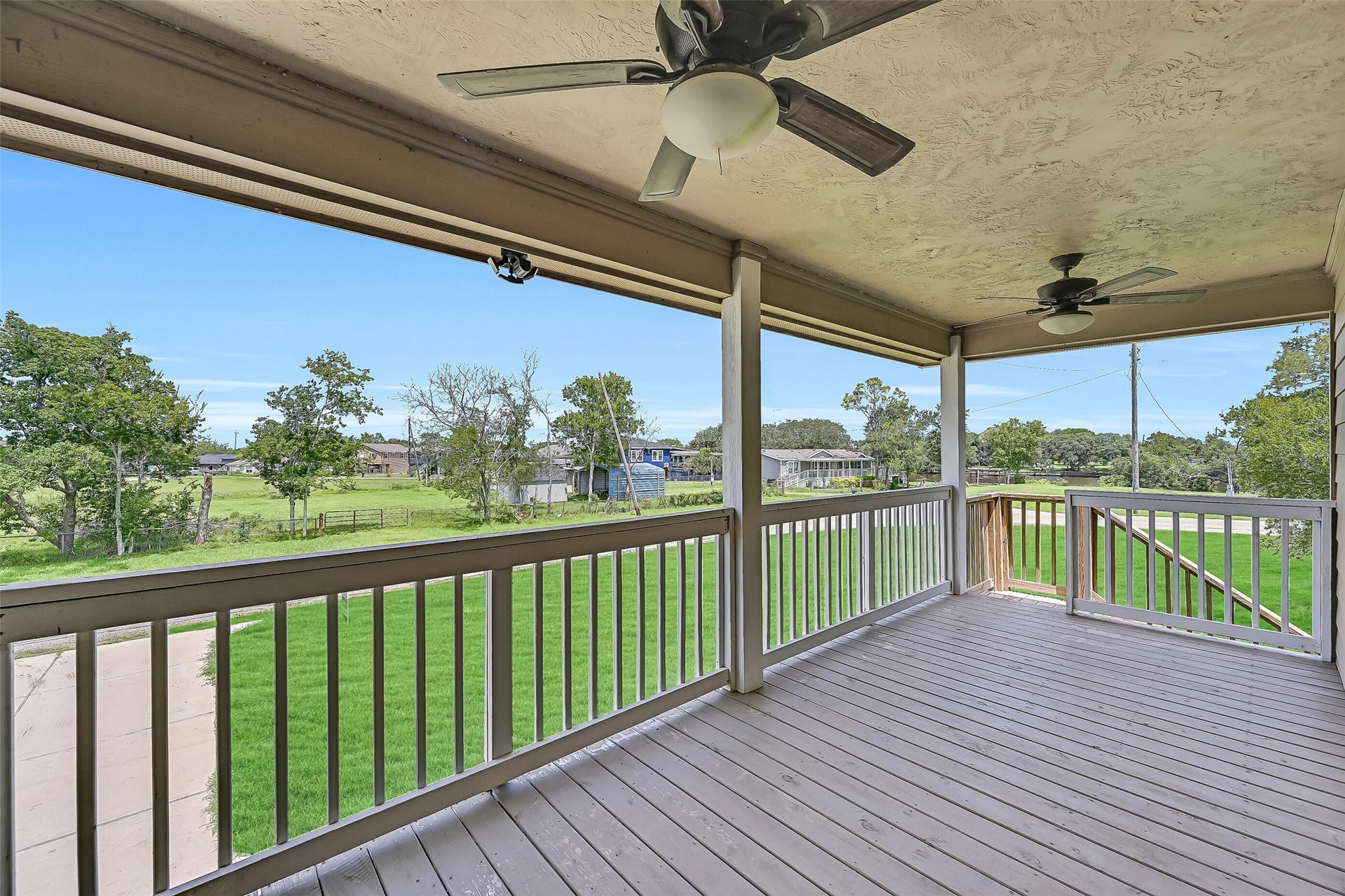 11930 Bastrop Beach Road, Angleton, TX 77515 Start your mornings with coffee or end your evenings watching the sunset from this spacious covered porch. Ceiling fans and plenty of room for outdoor seating make it an inviting extension of the home's living space.