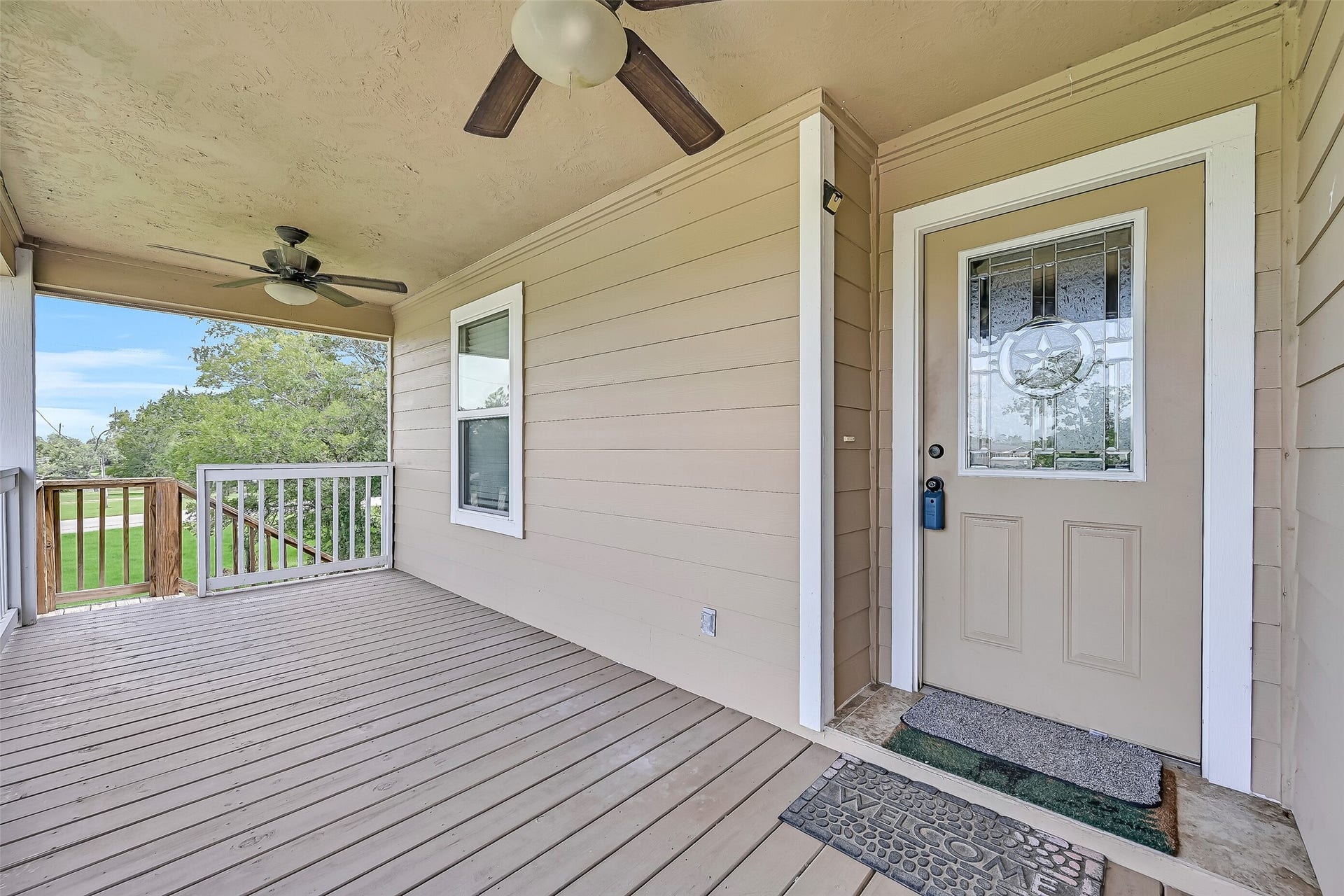 11930 Bastrop Beach Road, Angleton, TX 77515 A welcoming covered porch sets the tone before you even step inside, offering a comfortable place to relax while the decorative front door adds a touch of character to this custom-built home.