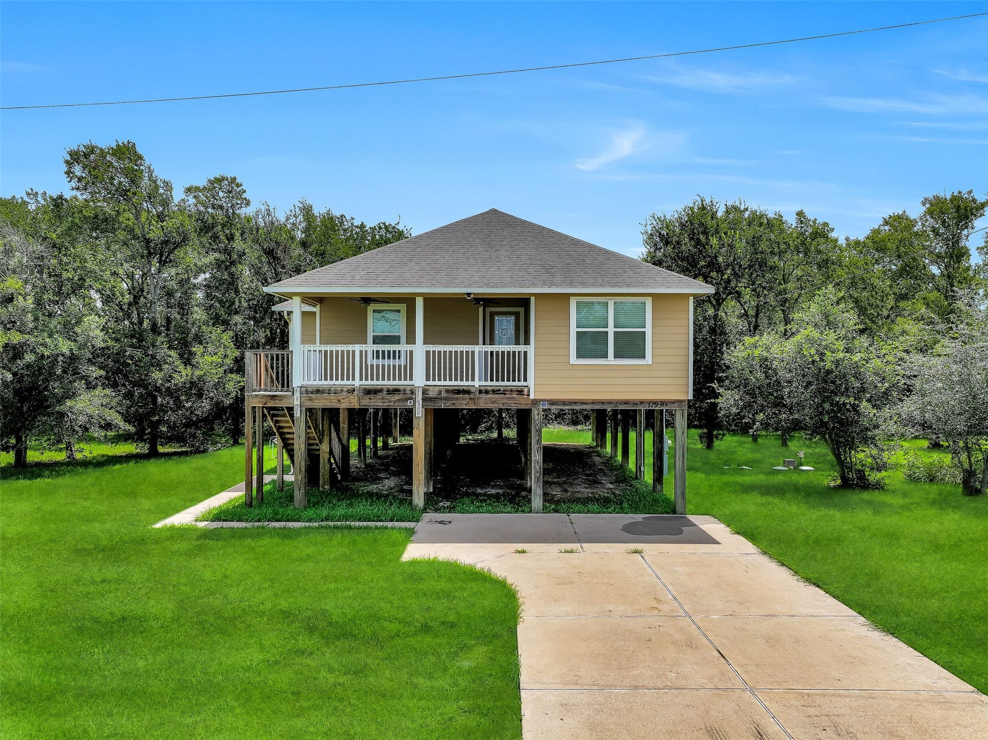 11930 Bastrop Beach Road, Angleton, TX 77515 The elevated design maximizes both function and outdoor living, with expansive green space surrounding the home and a covered front porch that invites you to slow down and enjoy the peaceful setting.