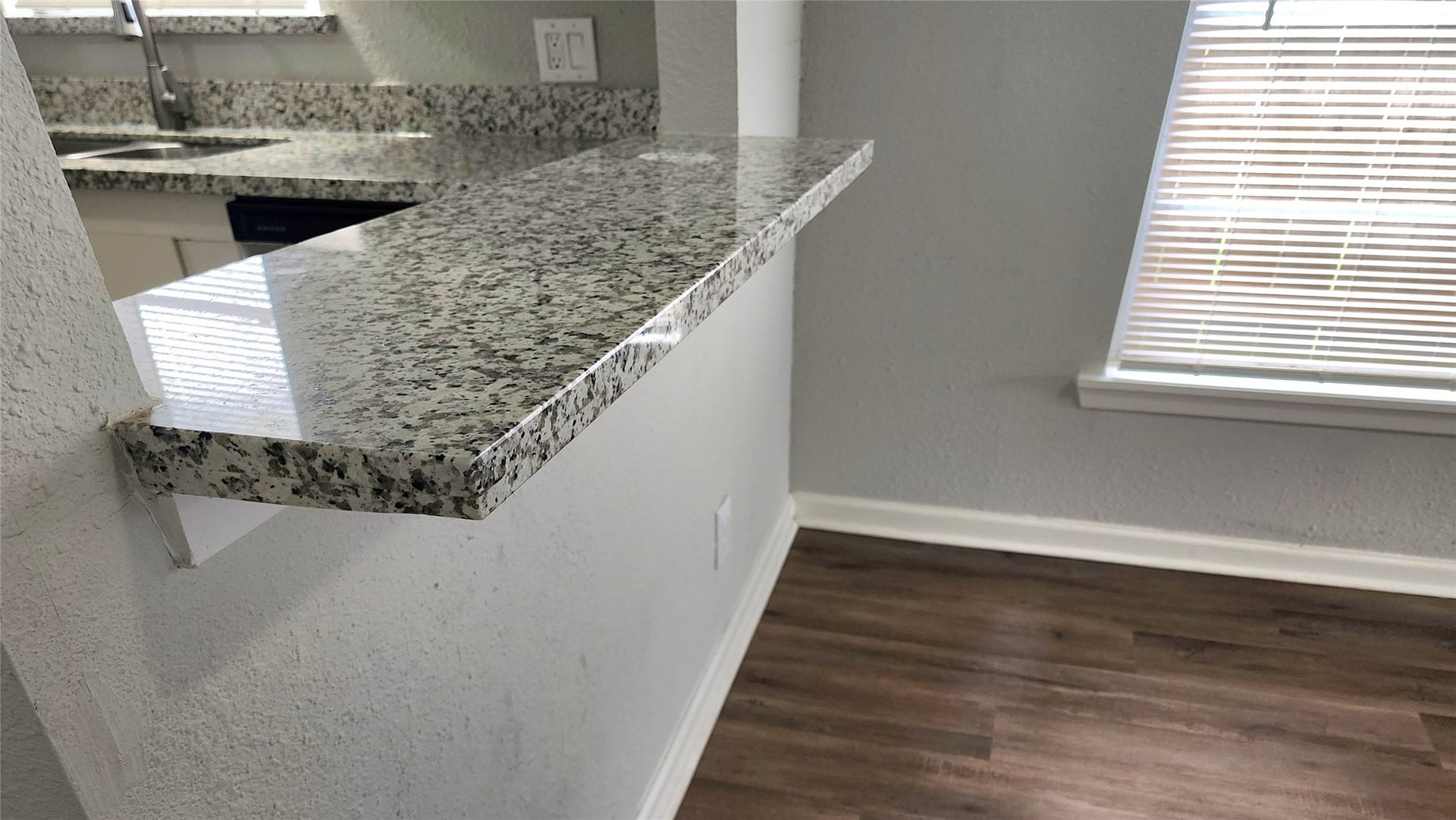 419 N Parrish Street, Angleton, TX 77515 Granite breakfast bar for quick meals or extra prep space.